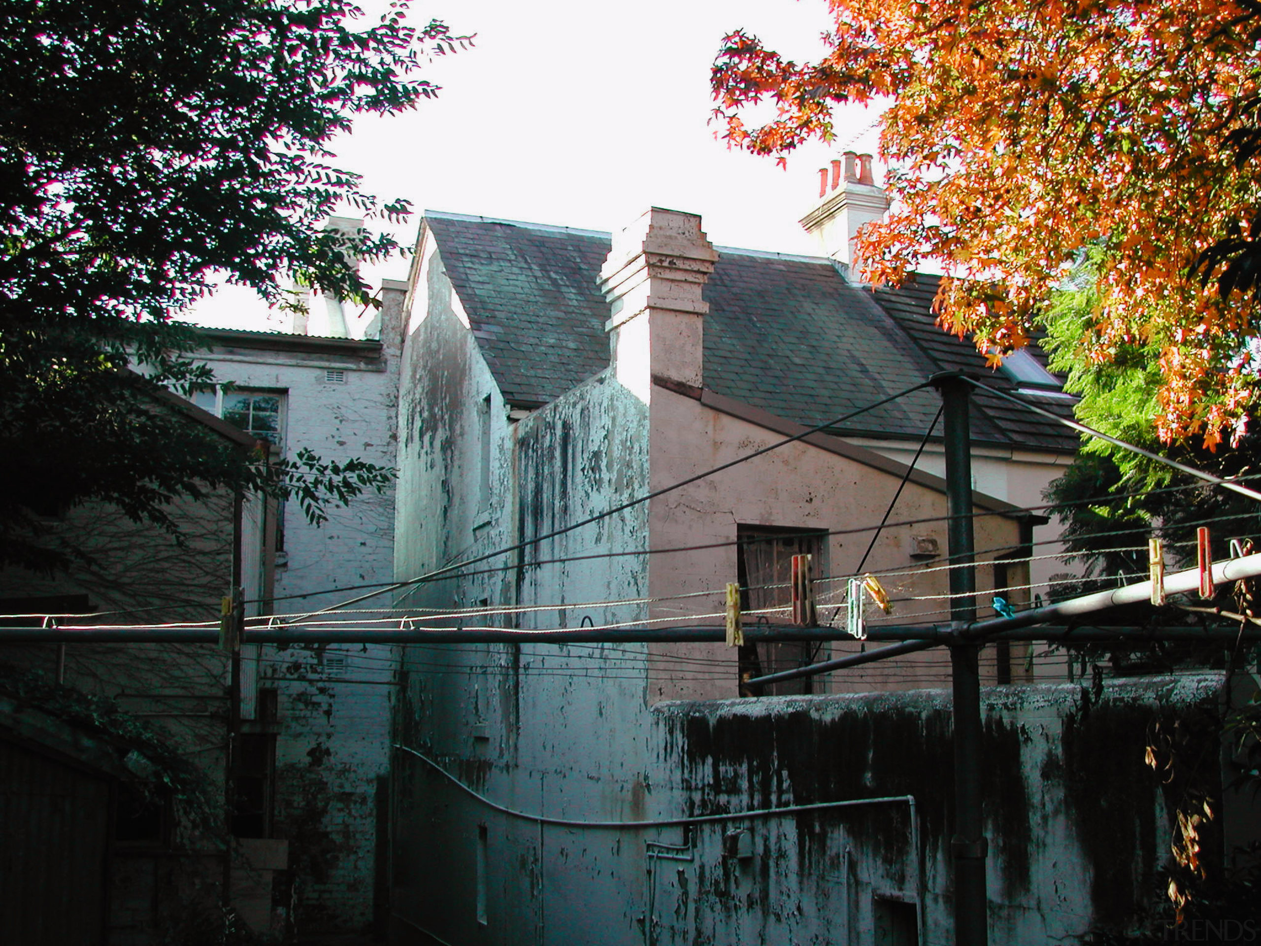 An exterior view of the apartments before they architecture, building, facade, house, leaf, neighbourhood, plant, reflection, roof, sky, tree, wall, water, window, black