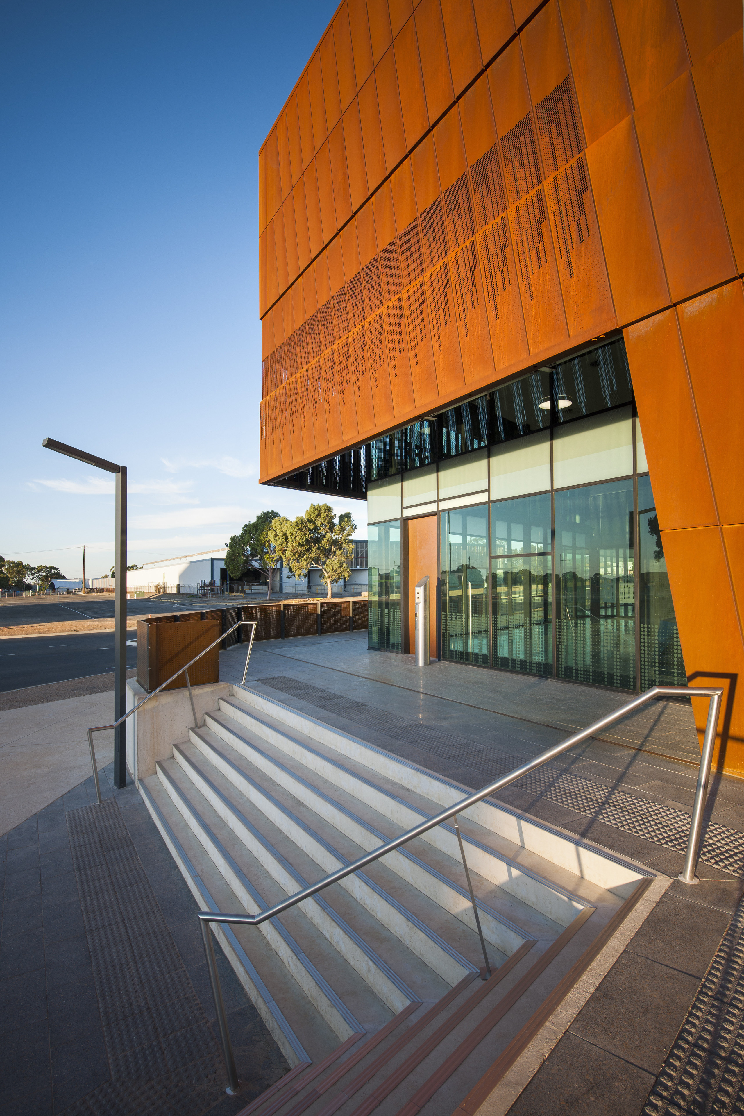 The lower section of the weathered steel facade architecture, building, commercial building, condominium, corporate headquarters, daylighting, facade, house, line, real estate, reflection, sky, sunlight, brown