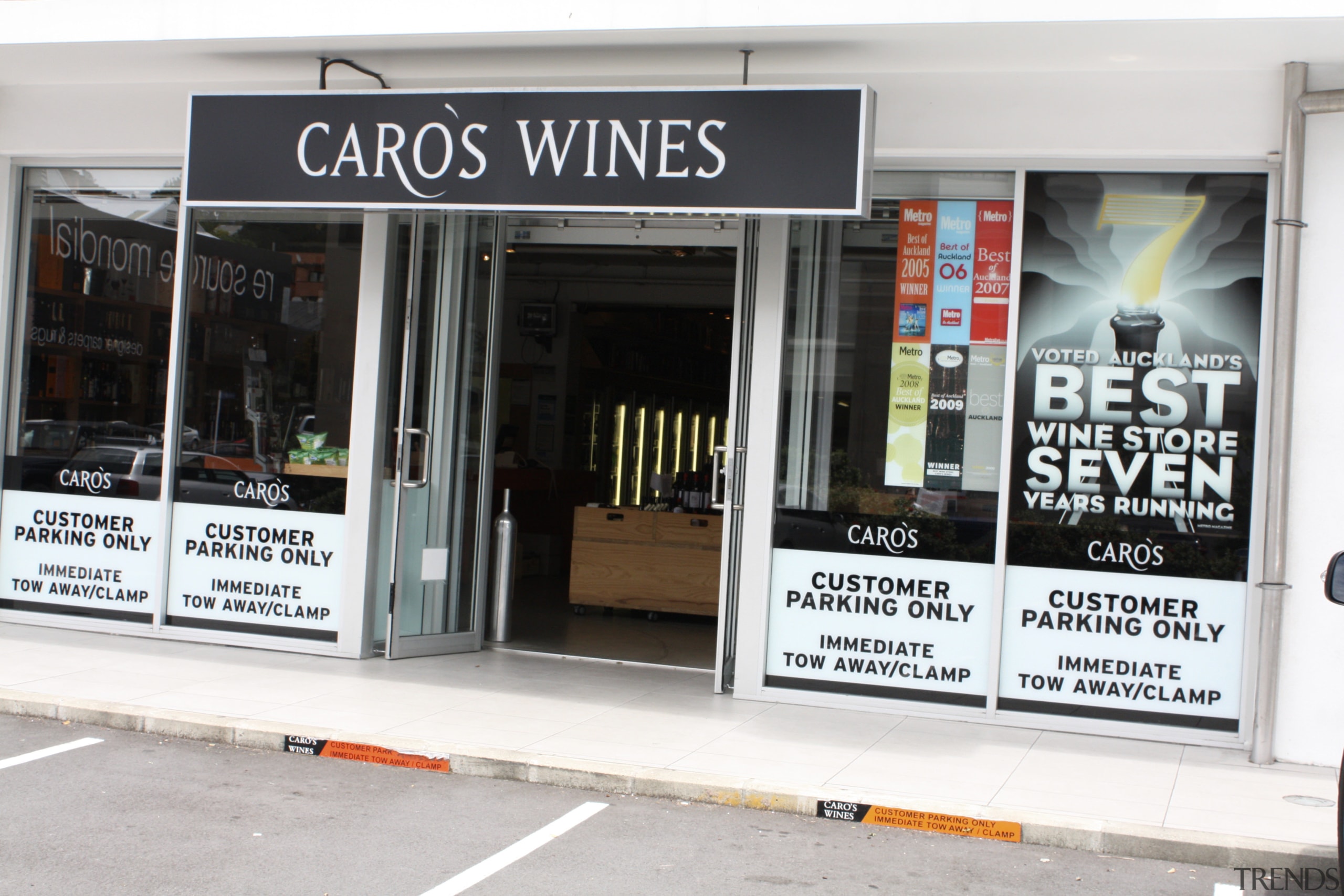 View of refrigeration solution at wine retailer. - advertising, window, white, black
