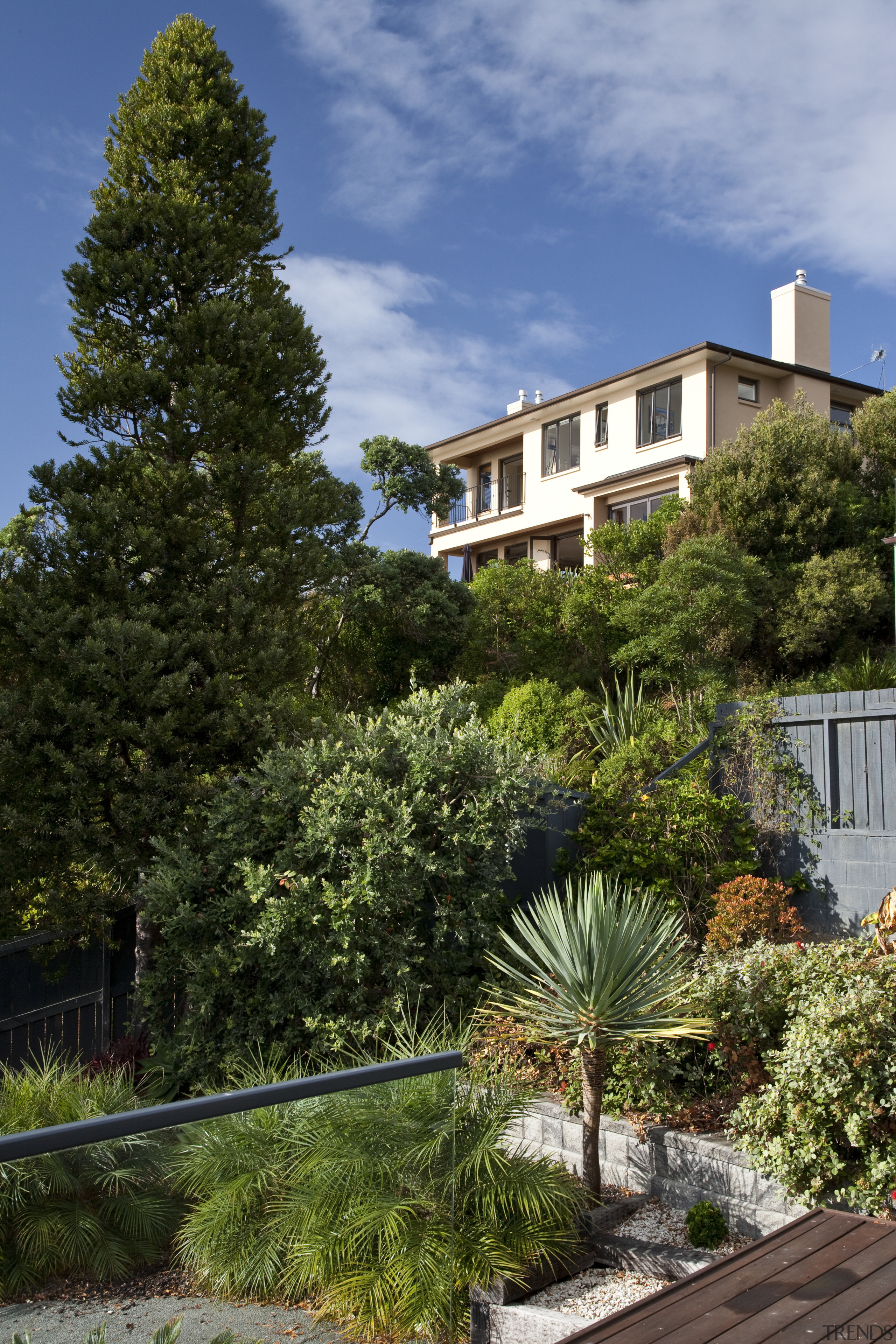 Exterior view of a home with Italian aesthetic architecture, cottage, estate, facade, garden, grass, home, house, landscape, landscaping, leaf, neighbourhood, plant, property, real estate, residential area, sky, suburb, tree, vegetation, villa, yard, brown