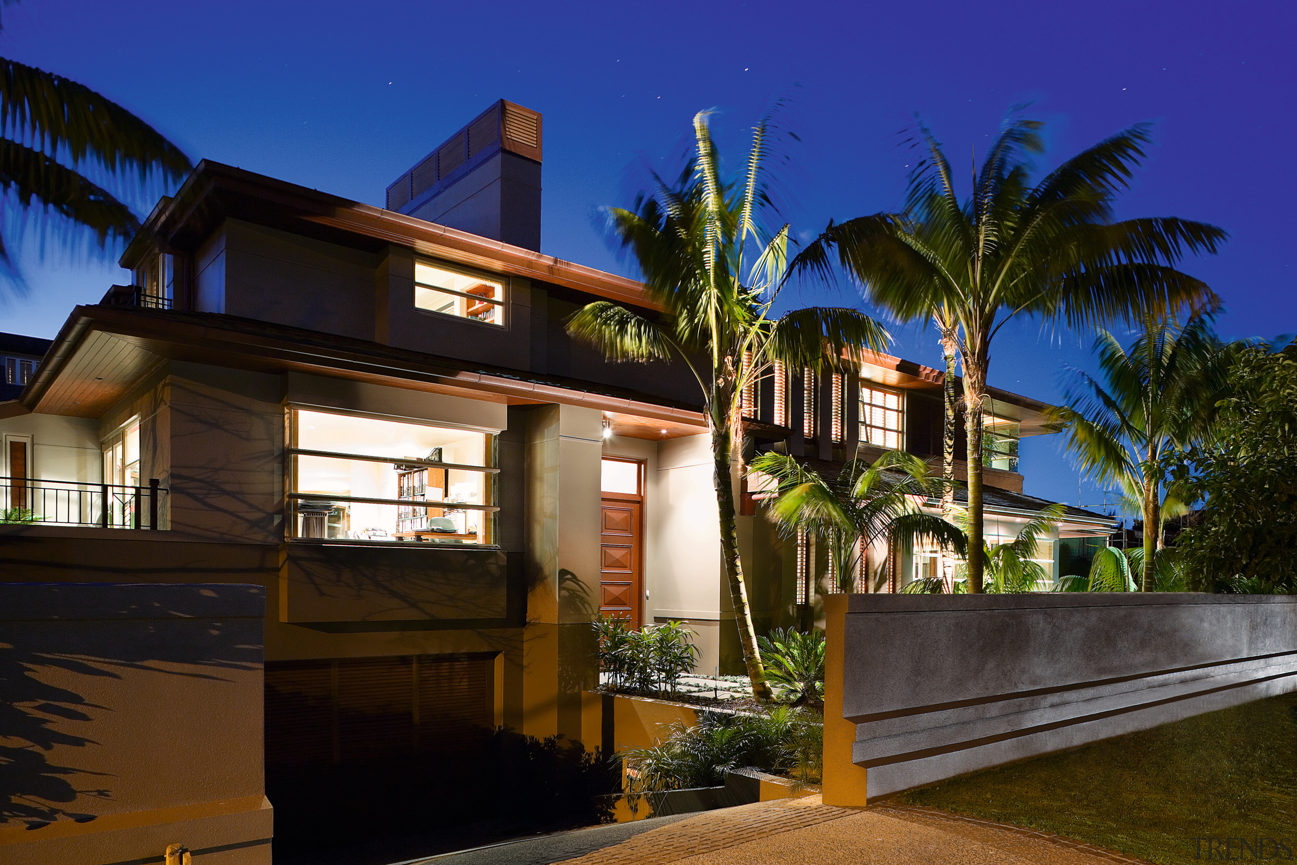 A view of a home by Santa Barbara architecture, arecales, building, cottage, estate, facade, home, house, lighting, night, palm tree, property, real estate, residential area, sky, villa, brown, blue