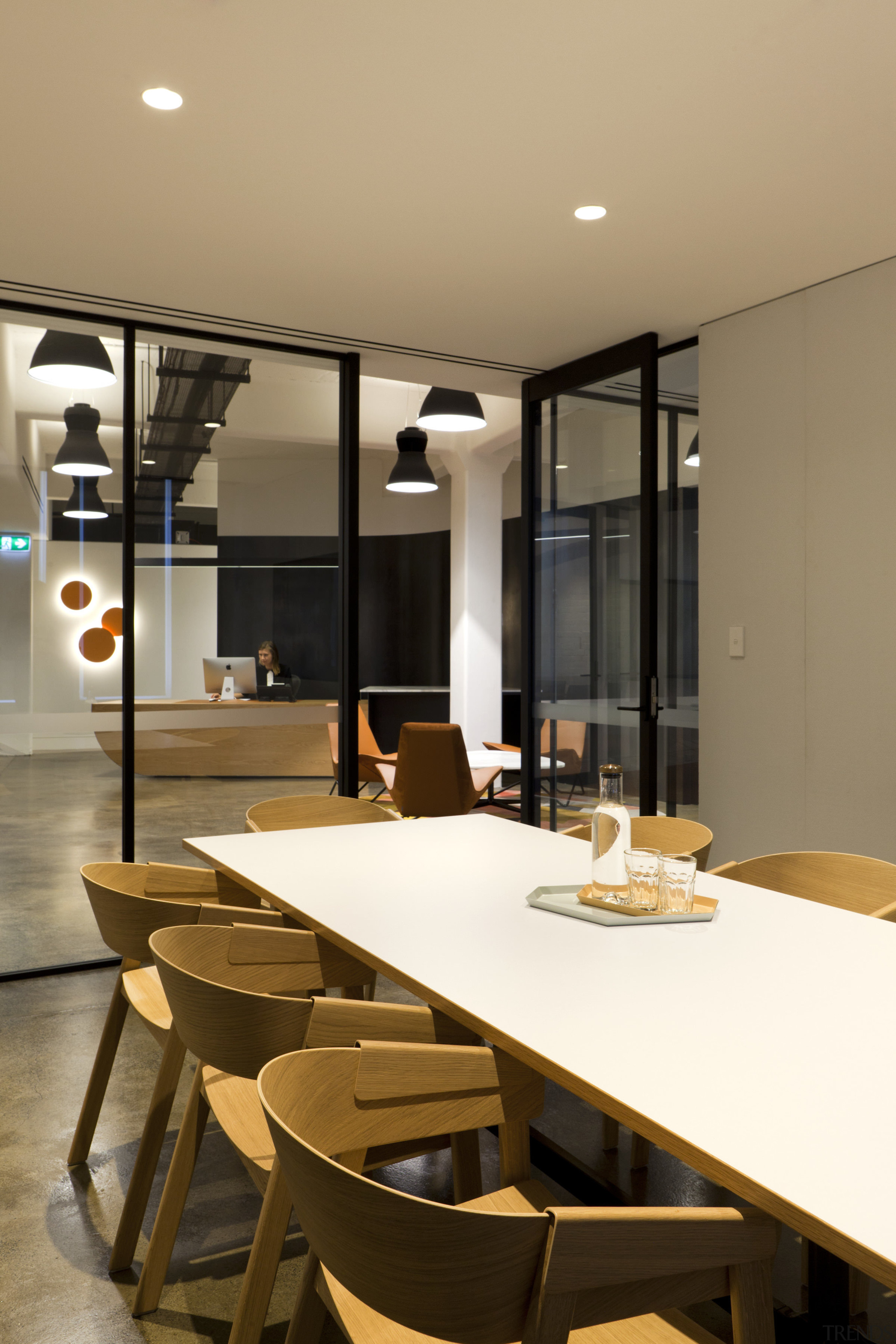 In this office fit-out, ceiling-height sliding doors combine dining room, furniture, interior design, room, table, brown, orange