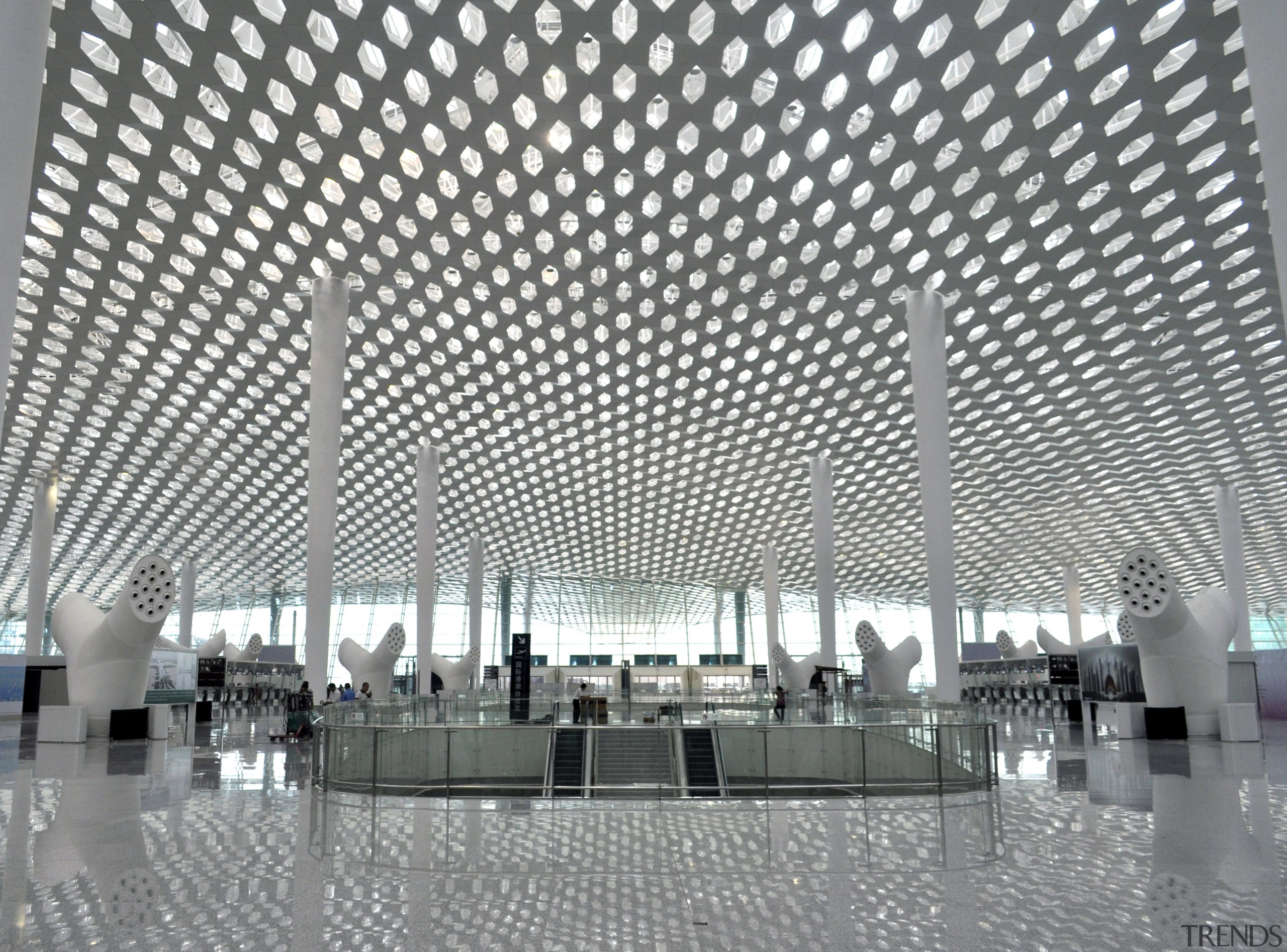 Looking much like a giant sculpture from both airport terminal, architecture, building, ceiling, convention center, corporate headquarters, daylighting, infrastructure, metropolis, metropolitan area, structure, symmetry, gray, white