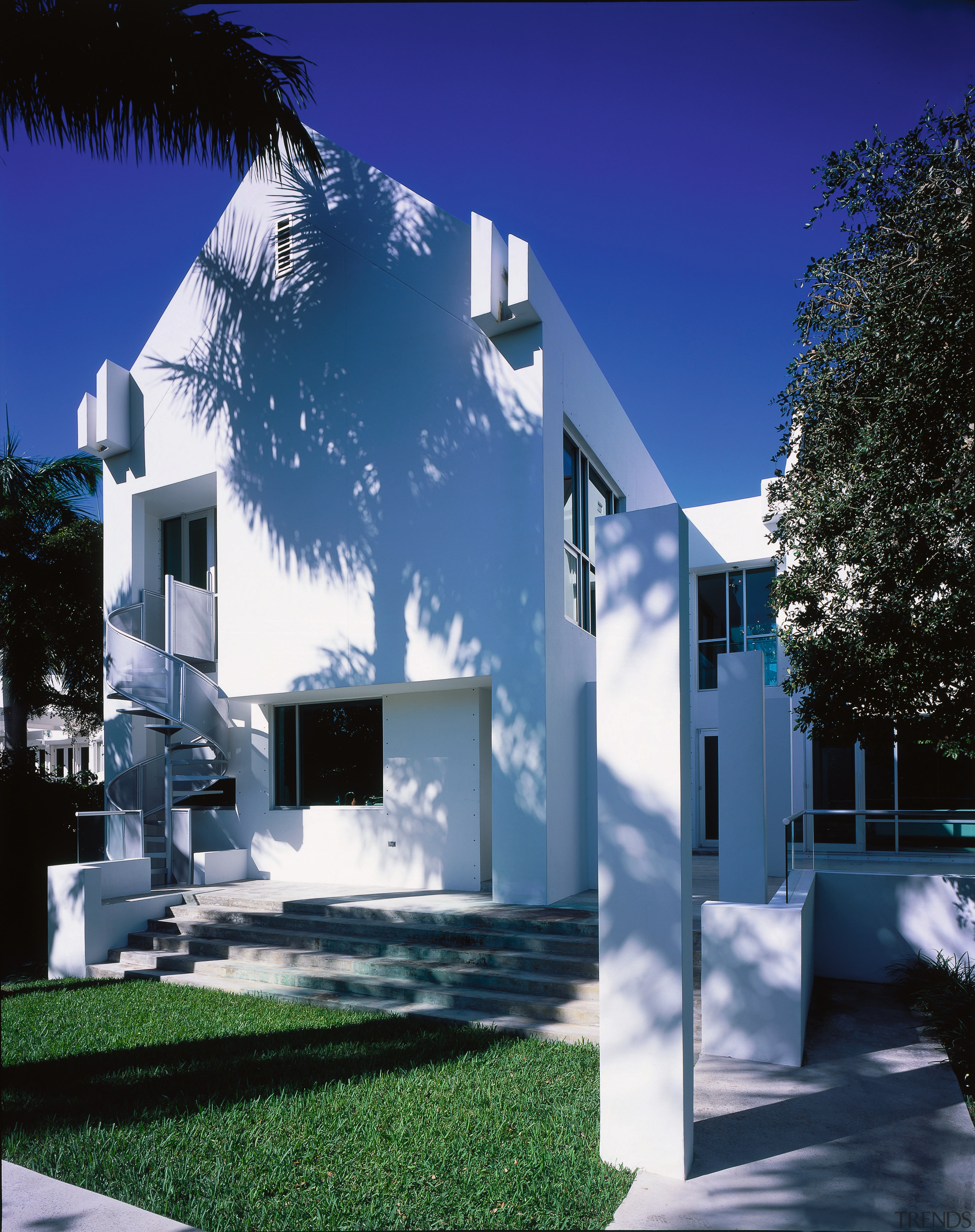 Exterior view of a white palstered house, winding architecture, building, condominium, corporate headquarters, daytime, elevation, estate, facade, home, house, property, real estate, residential area, sky, blue