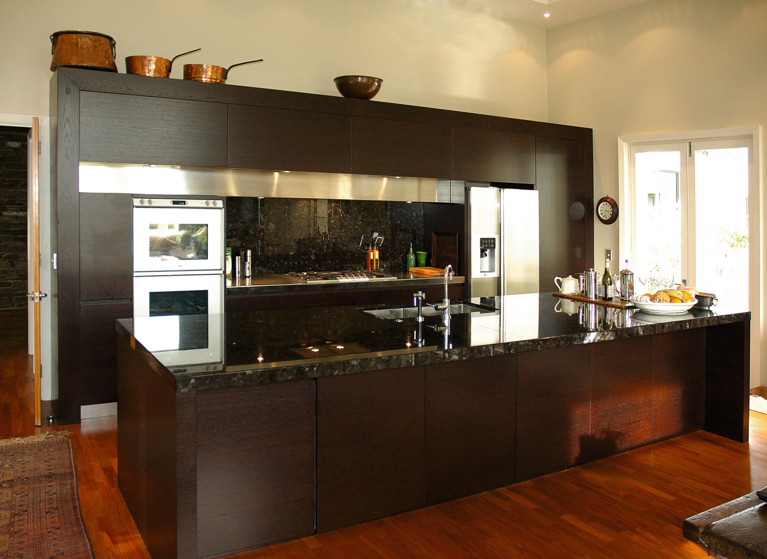 a view of this kitchen featuring bold dark cabinetry, countertop, cuisine classique, interior design, kitchen, room, brown