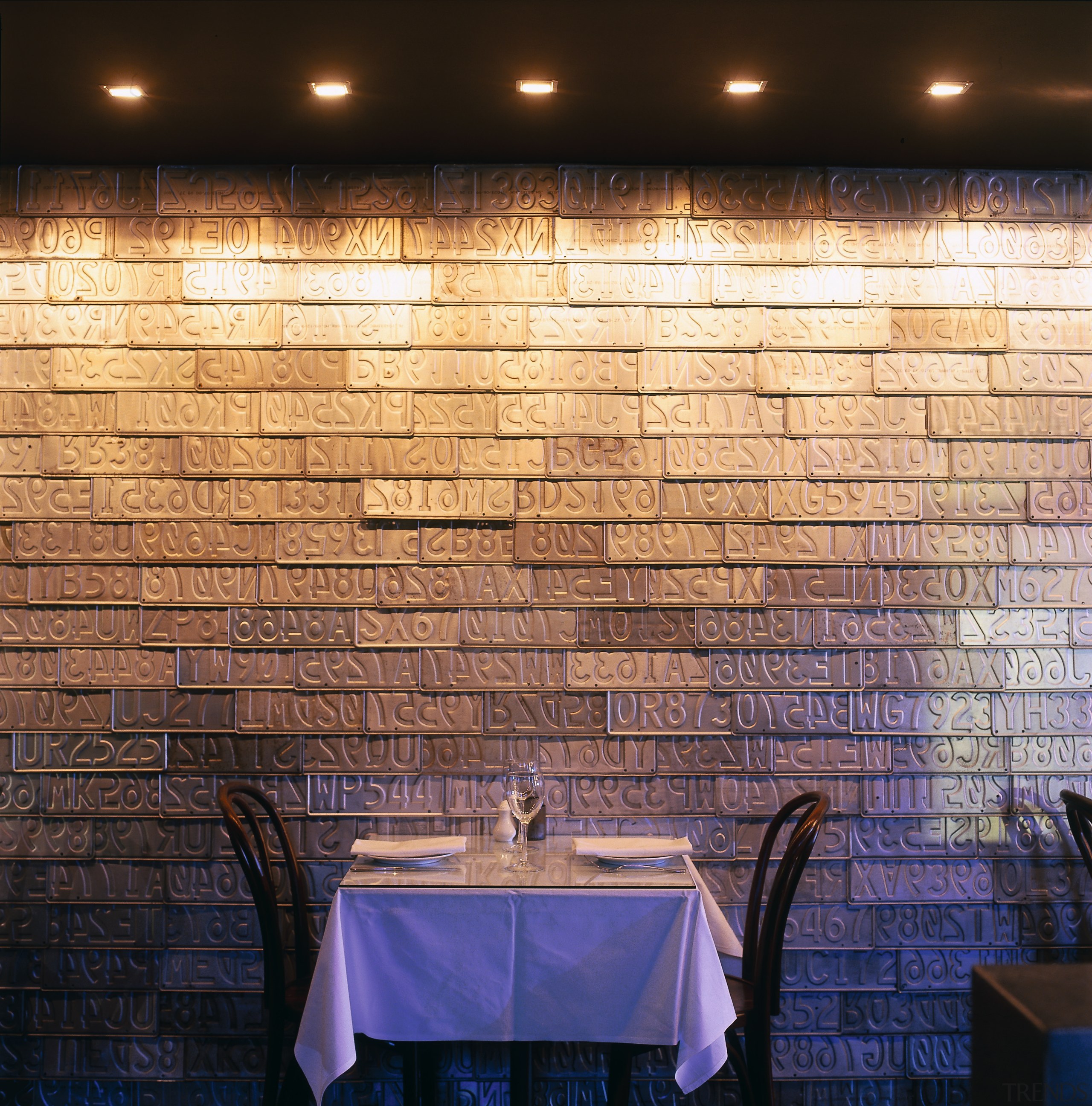 Restaurant table and chairs against feature wall of ceiling, daylighting, flooring, interior design, light, lighting, tile, wall, wood, black