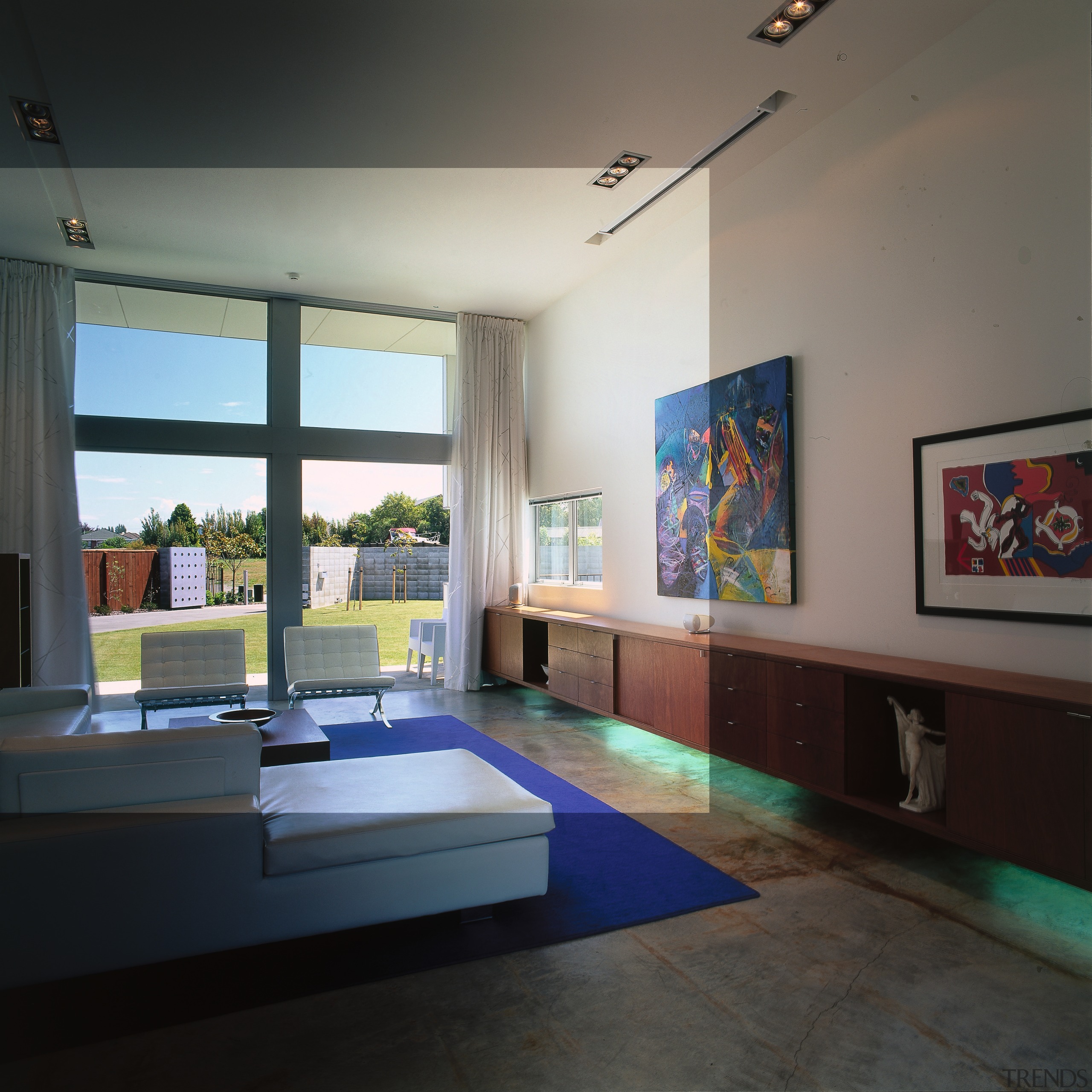 A view of the living area featuring white interior design, table, black, gray