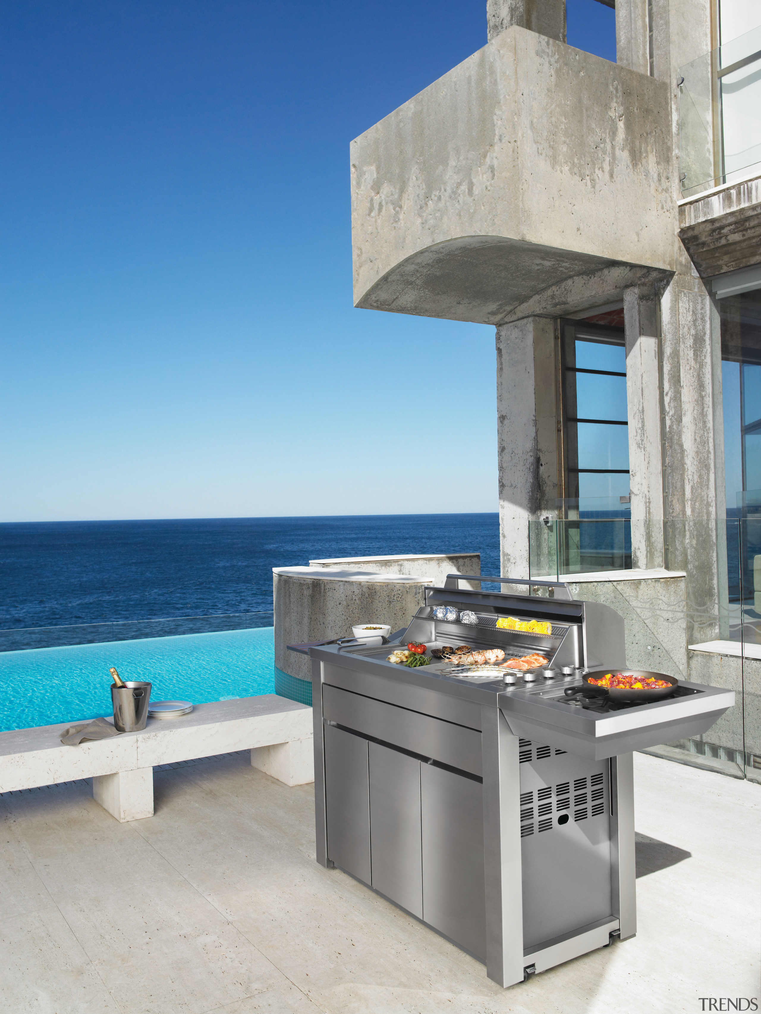 View of an outdoor entertaining area with barbeque furniture, table, gray