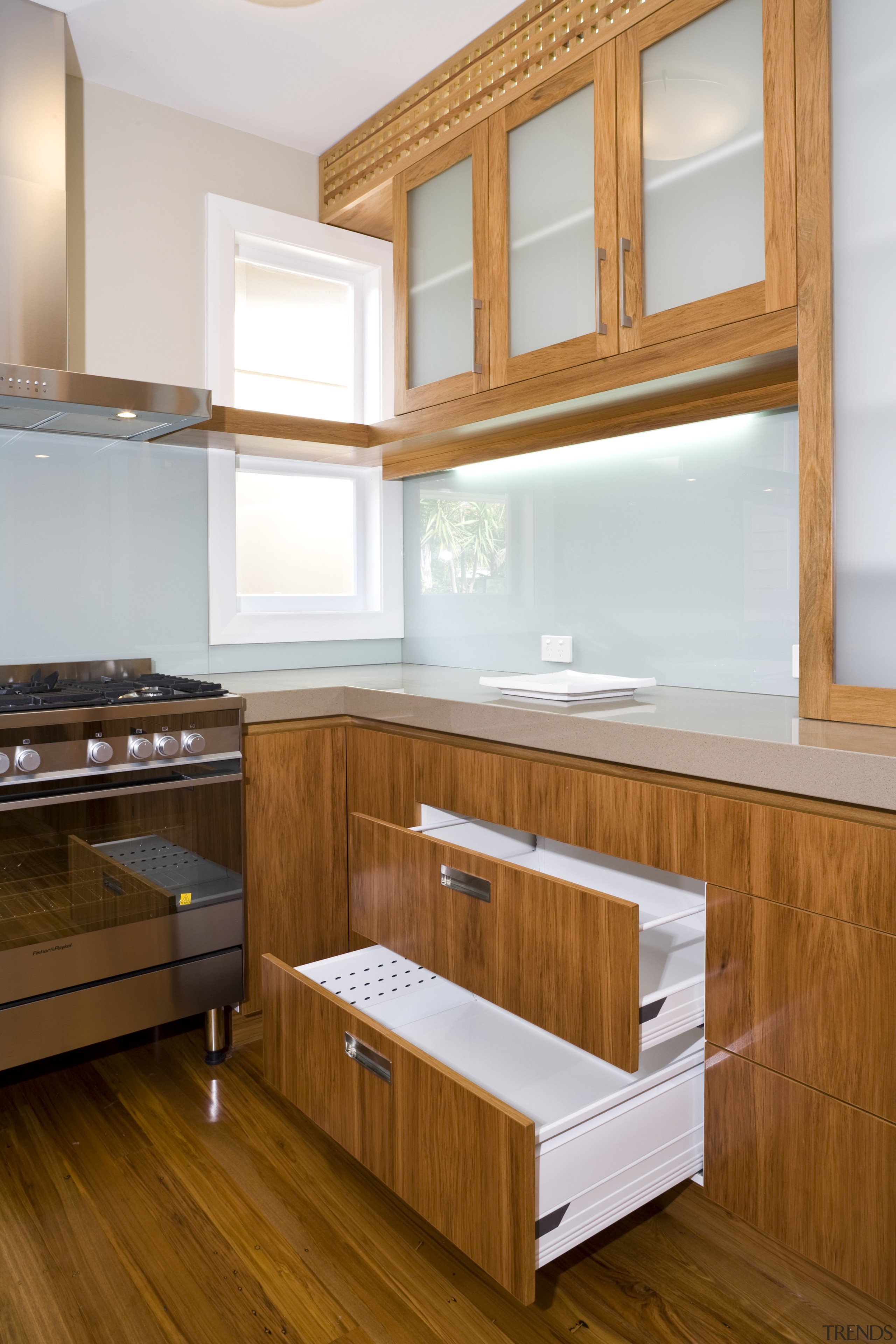 Image of kitchen designed by Rob Hendrickx for cabinetry, countertop, drawer, floor, flooring, furniture, hardwood, interior design, kitchen, room, shelf, shelving, wood, wood flooring, wood stain, brown, white
