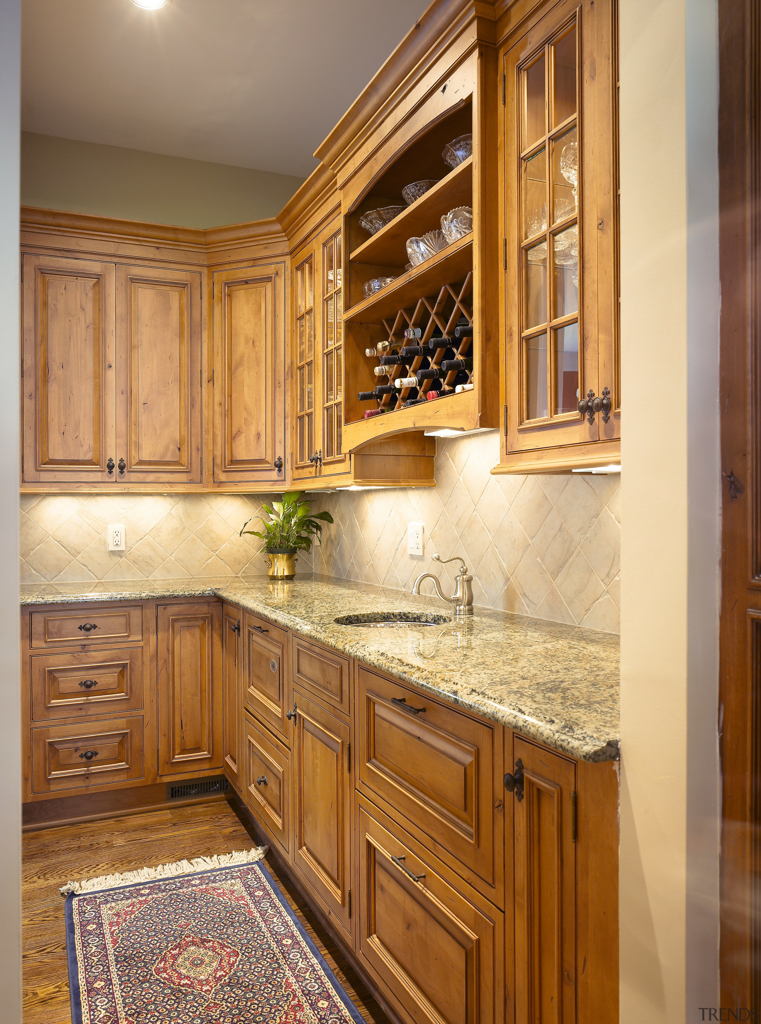 A view of this kitchen featuring Plato Woodwork cabinetry, countertop, cuisine classique, flooring, furniture, hardwood, home, interior design, kitchen, room, under cabinet lighting, wall, wood stain, brown, orange