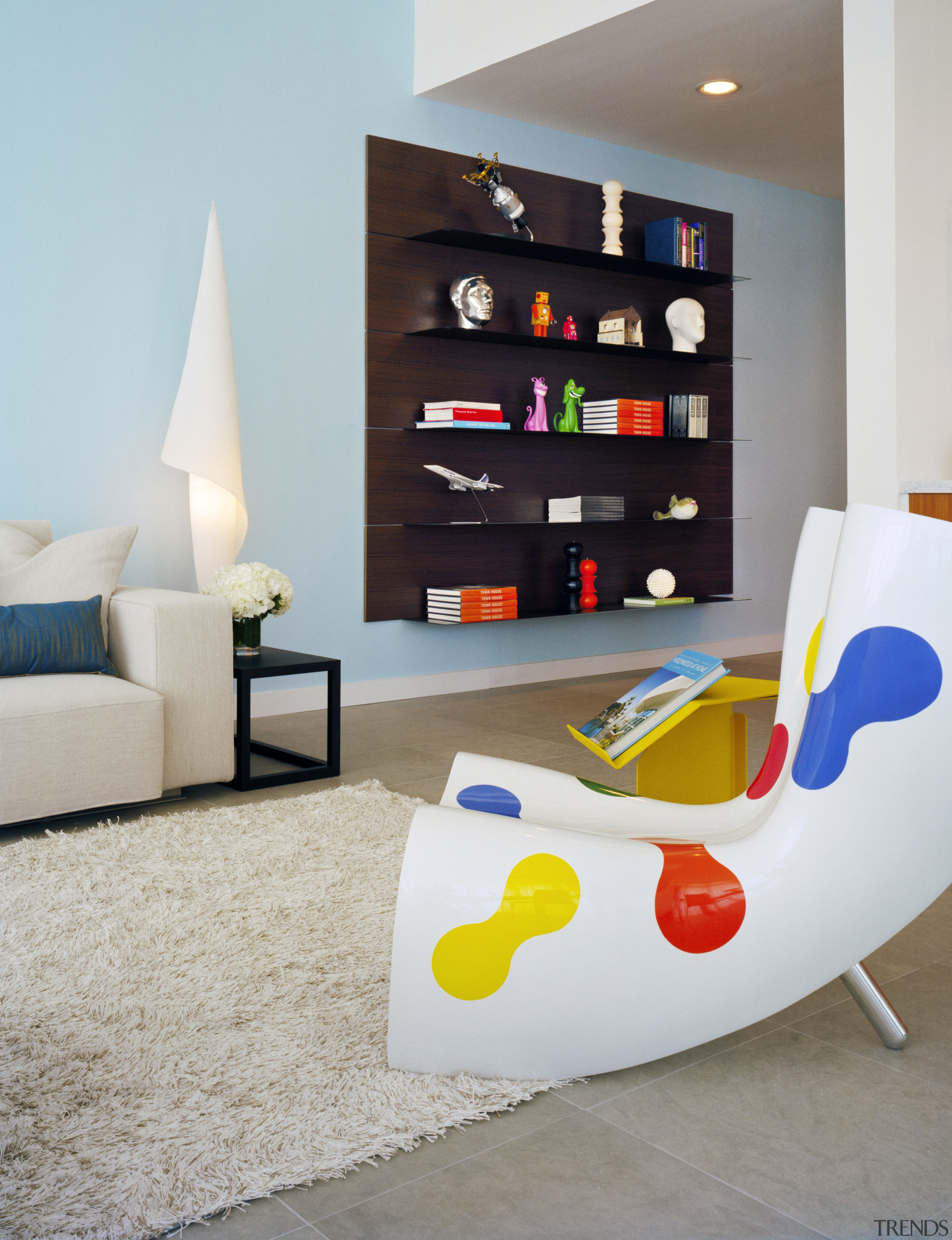 An interior view of this contemporary living area chair, furniture, interior design, living room, product, product design, room, shelf, shelving, table, wall, gray