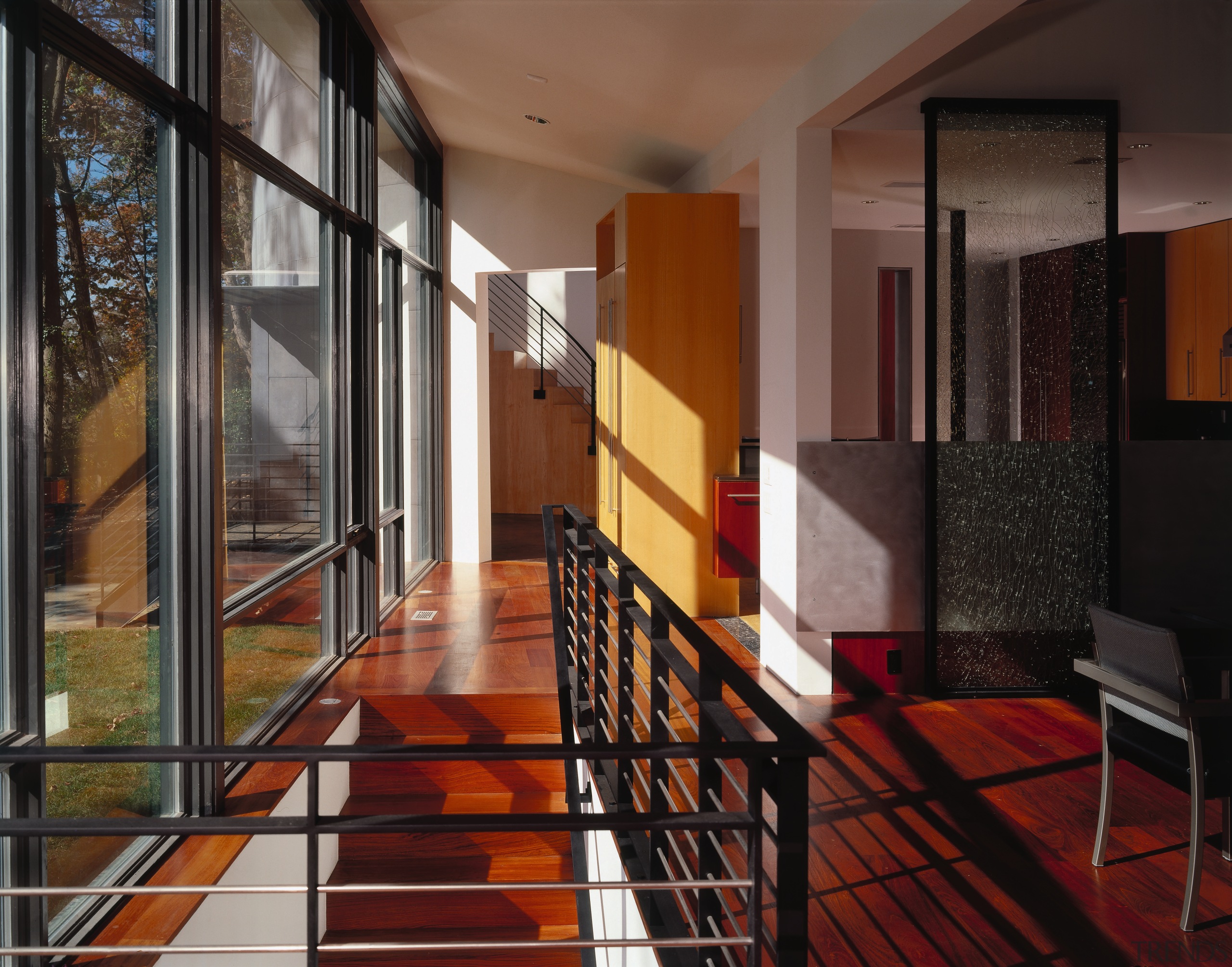 A view of a hallway, wooden flooring, large apartment, architecture, condominium, estate, facade, floor, flooring, handrail, house, interior design, lobby, loft, property, real estate, stairs, wall, window, black, brown