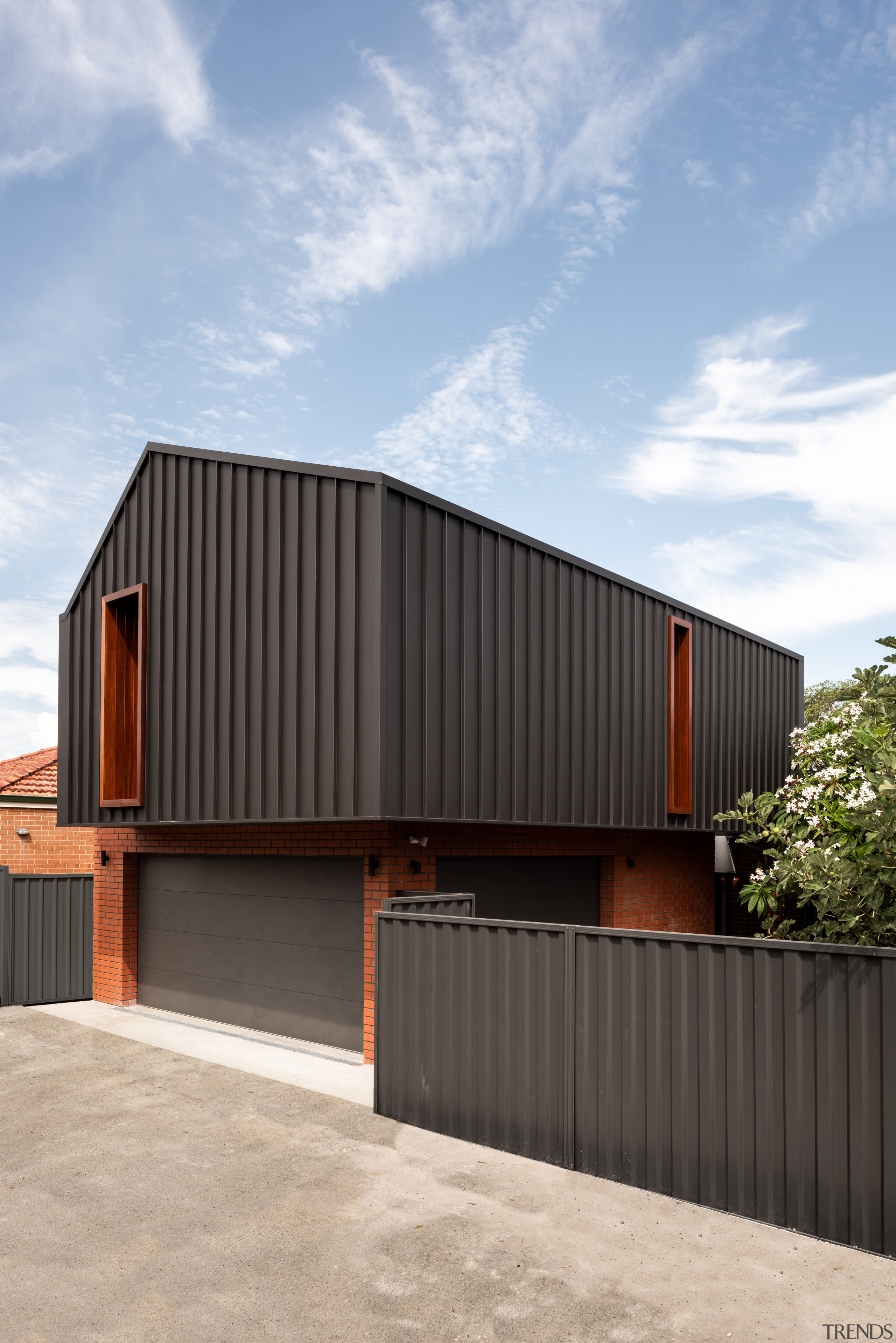 The brickwork on the garage/master suite extension echoes 