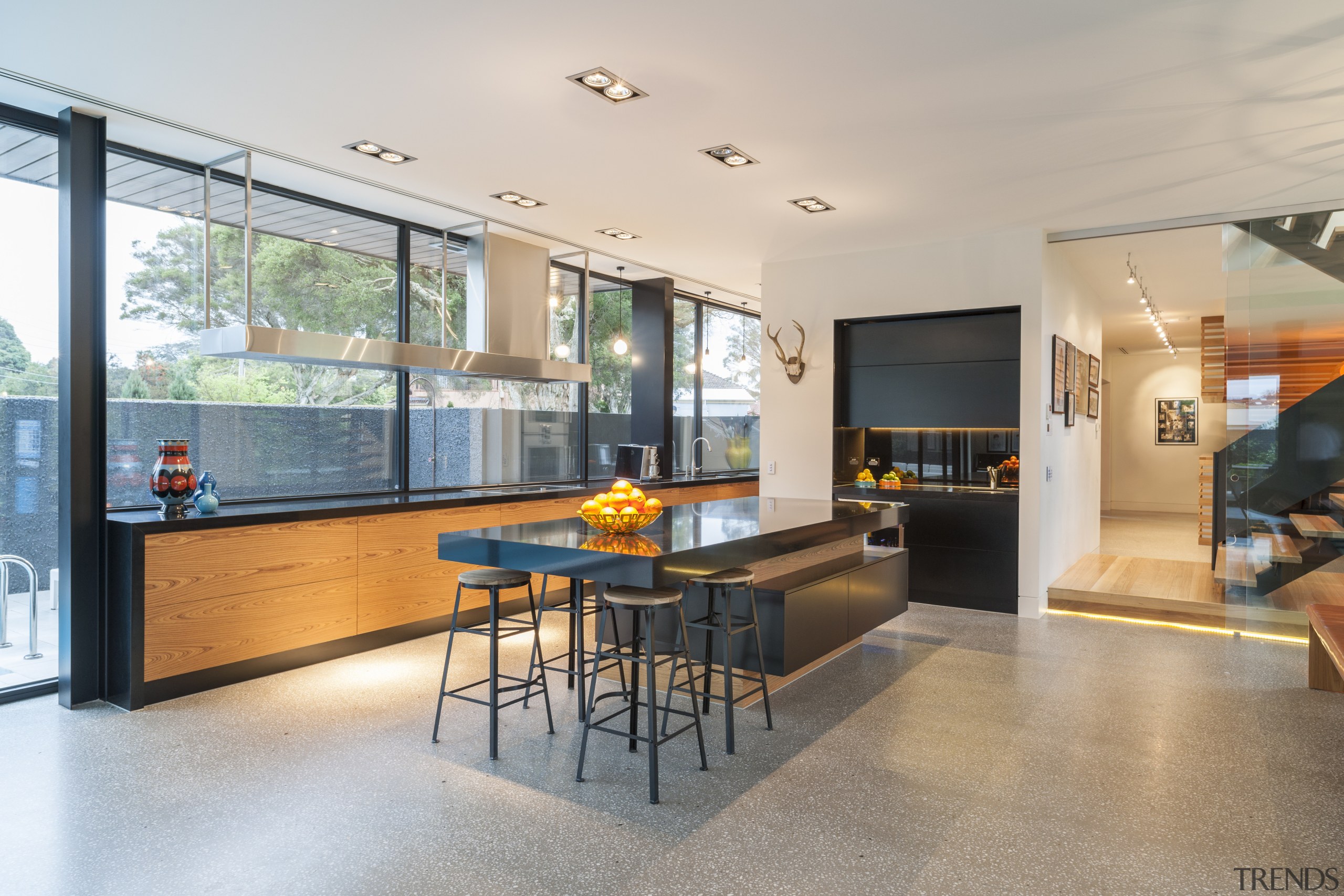 Rich orange wood veneer balances jet black engineered architecture, house, interior design, living room, real estate, gray