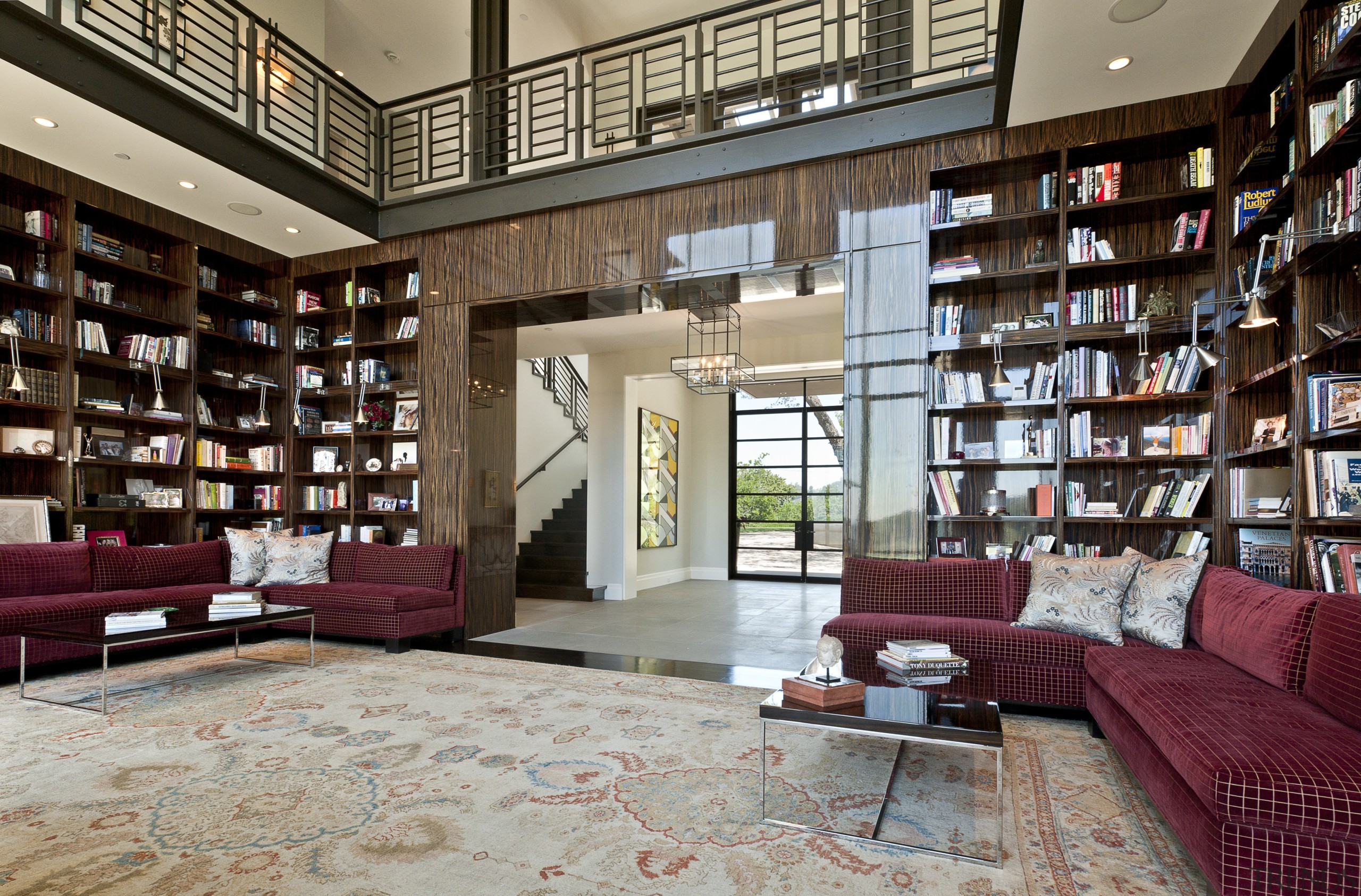 View of the library that features shelving and bookcase, bookselling, estate, institution, interior design, library, living room, lobby, loft, public library, real estate, shelving, gray