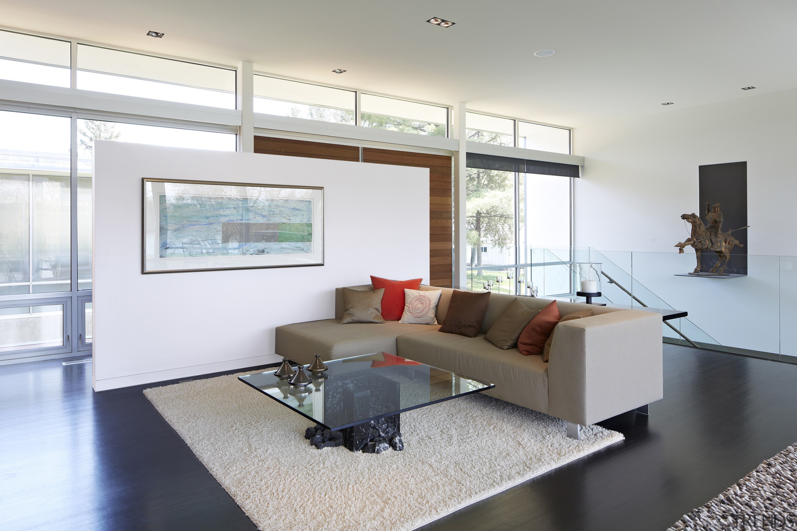 This open-plan living area is separated from the architecture, ceiling, daylighting, floor, flooring, house, interior design, living room, property, real estate, room, window, white, gray