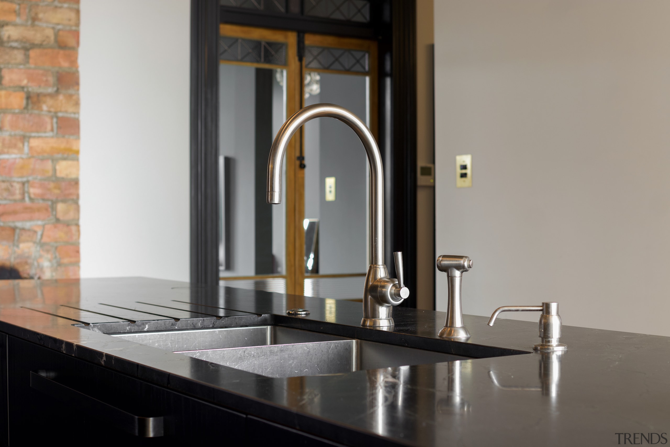 Pewter toned taps and pourer complement the island's 