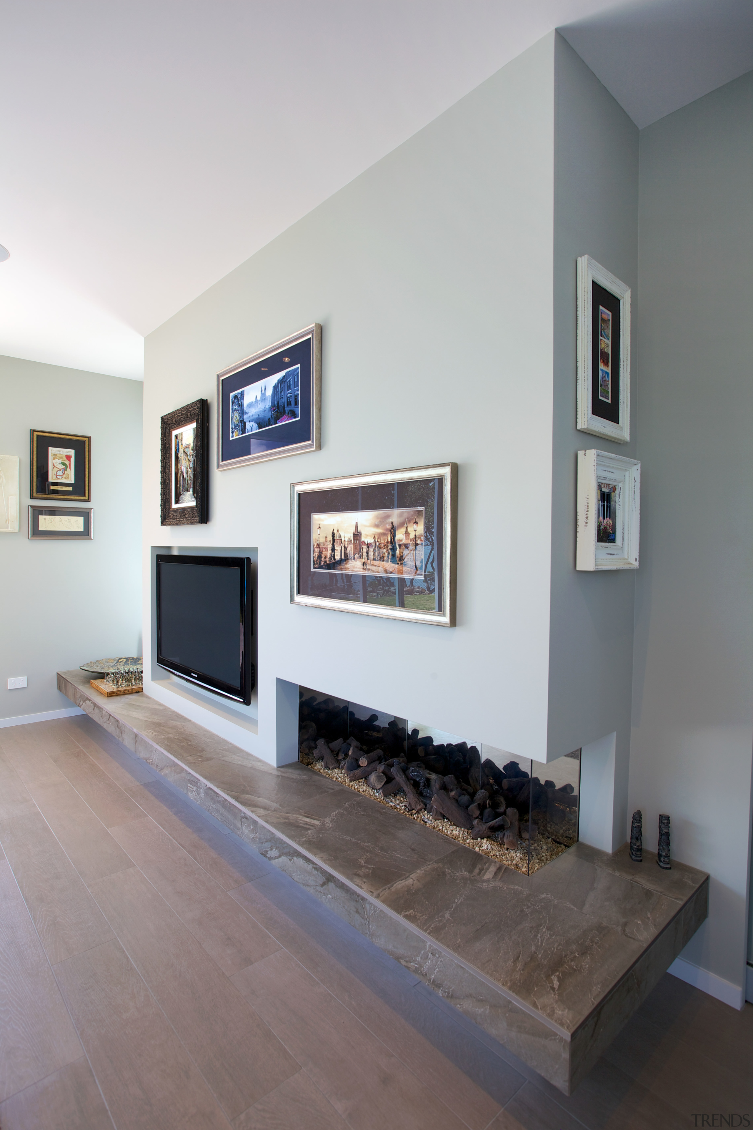 Designer colours set off the interior of this fireplace, floor, hearth, home, interior design, living room, room, wall, gray