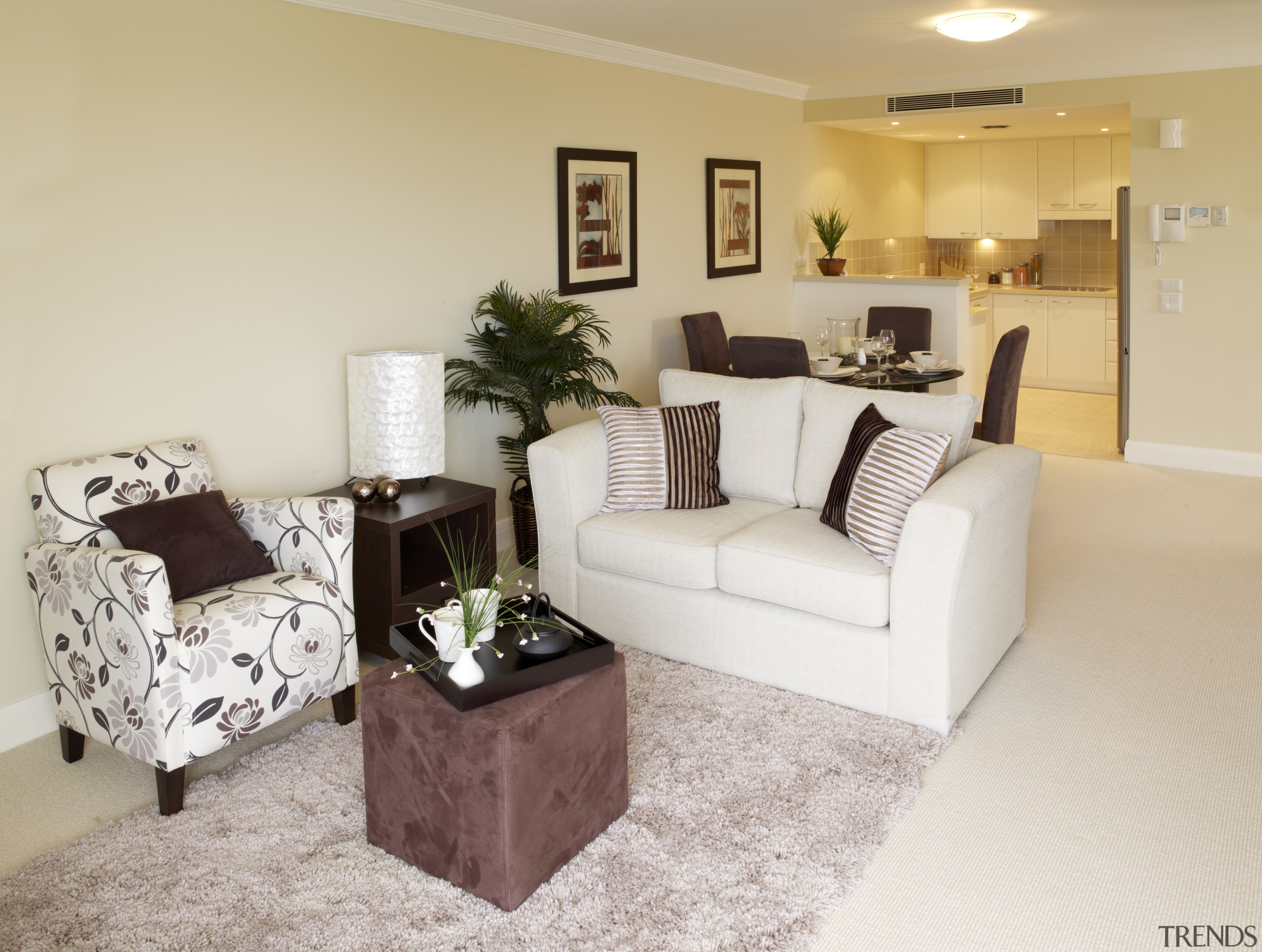 View of the lounge area of a unit couch, floor, flooring, furniture, home, interior design, living room, property, real estate, room, gray, orange