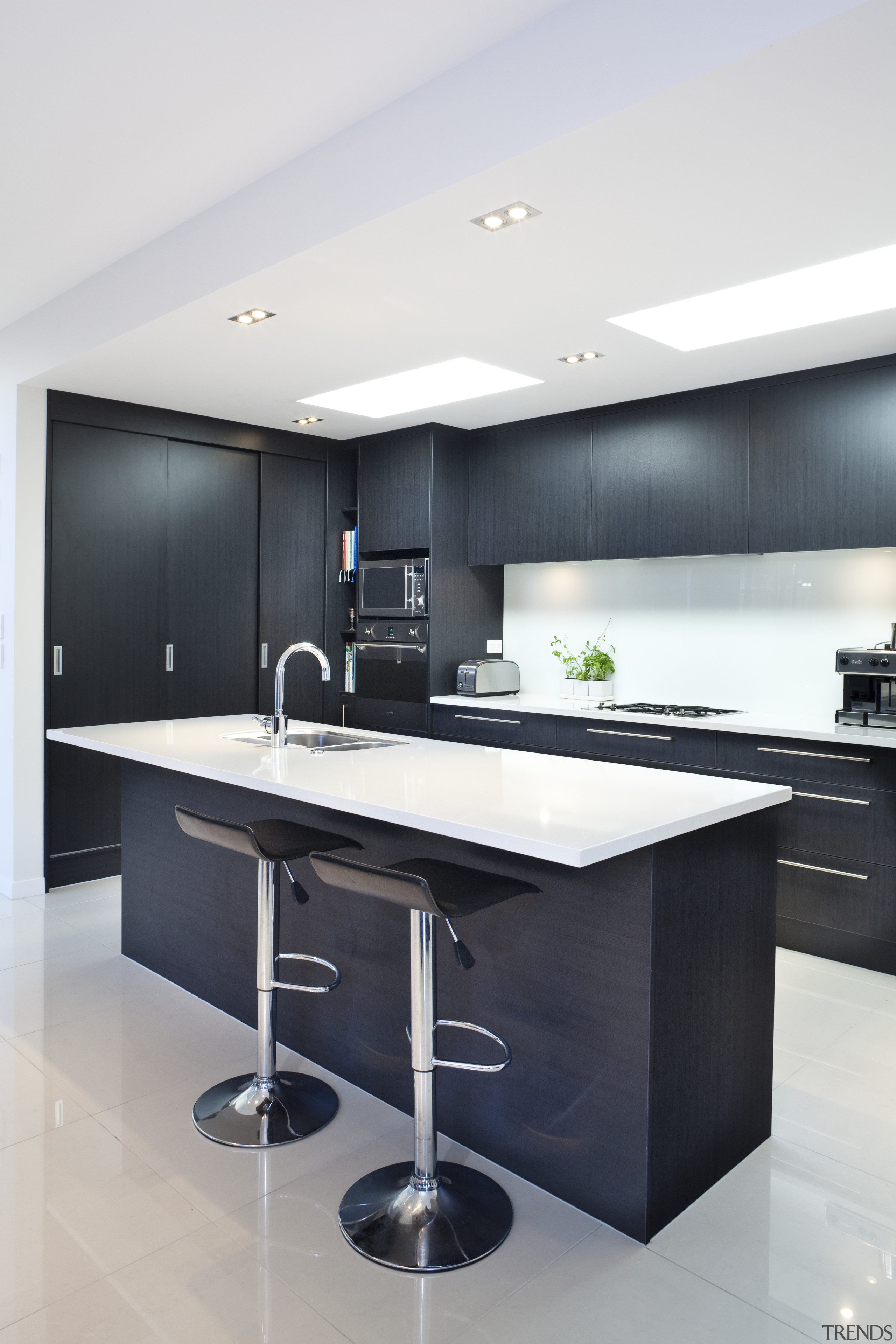 View of kitchen with dark toned cabinets and cabinetry, countertop, interior design, kitchen, product design, white, black