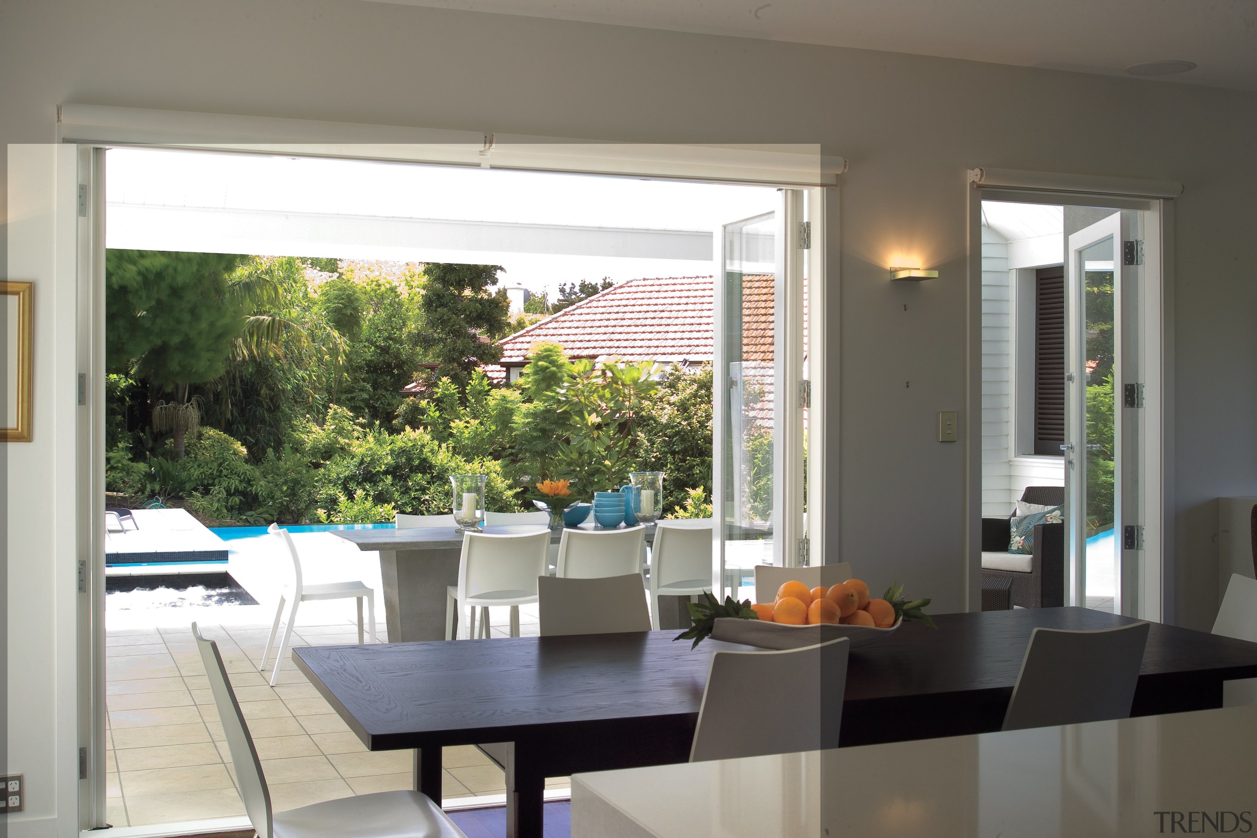 A view of the dining area looking out architecture, daylighting, dining room, door, home, house, interior design, real estate, table, window, window covering, window treatment, gray