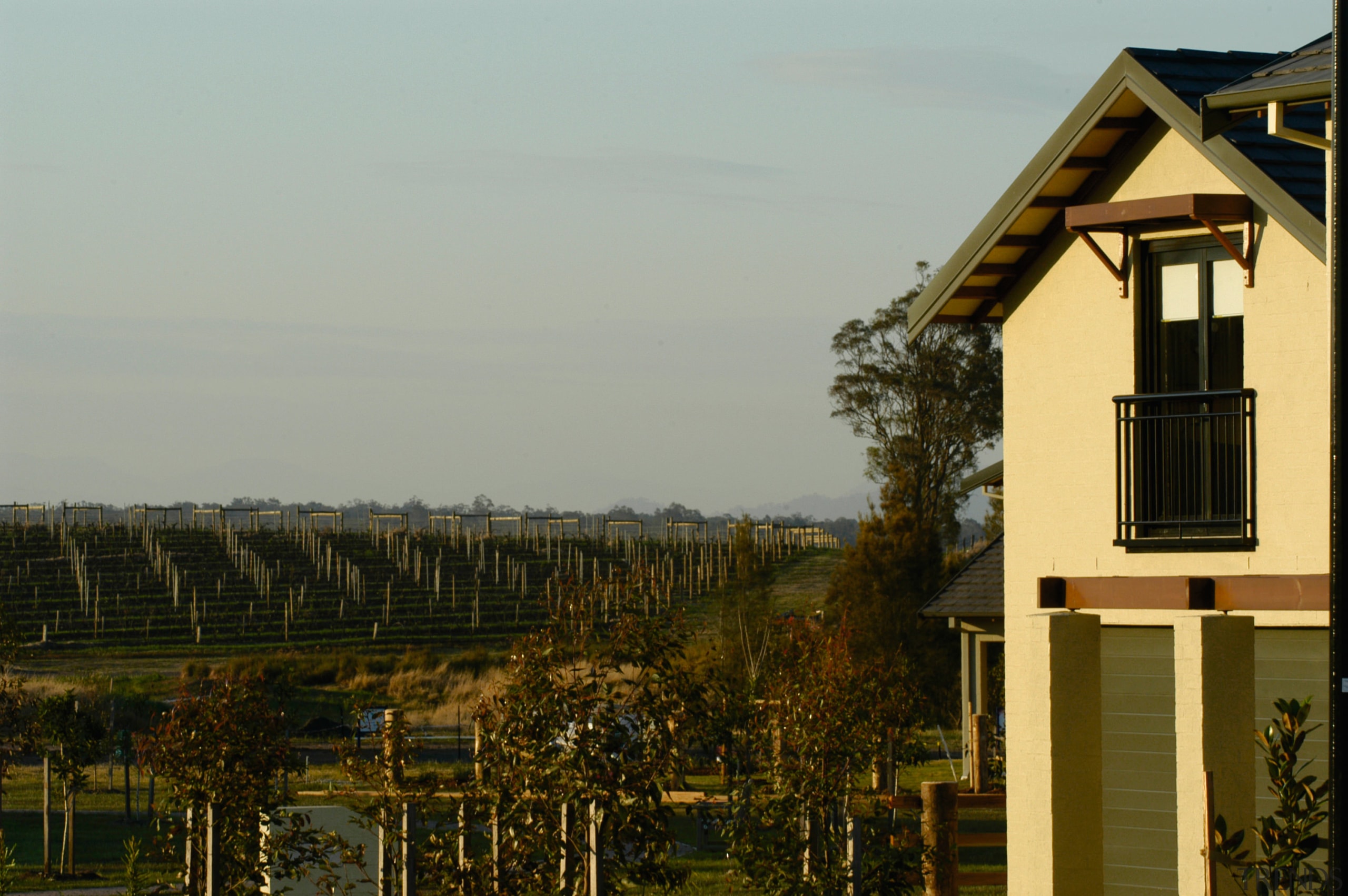 View of the house from the outside - building, cottage, home, house, plant, residential area, rural area, sky, tree, wood, gray, brown