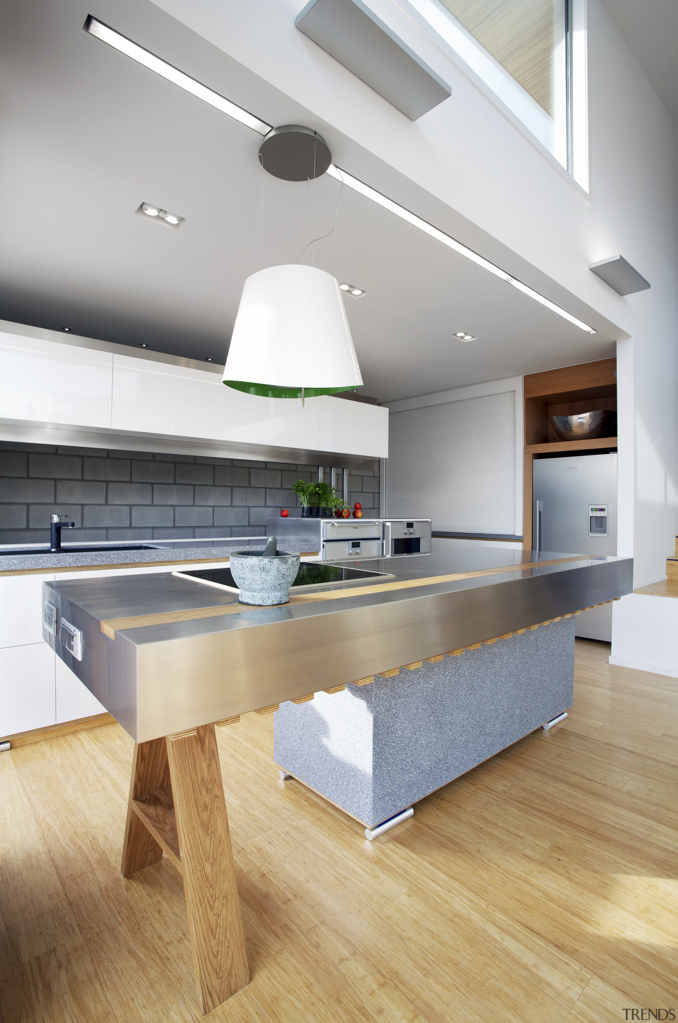 This kitchen features stainless steel benchtops. It was countertop, floor, hardwood, interior design, kitchen, table, wood flooring, gray