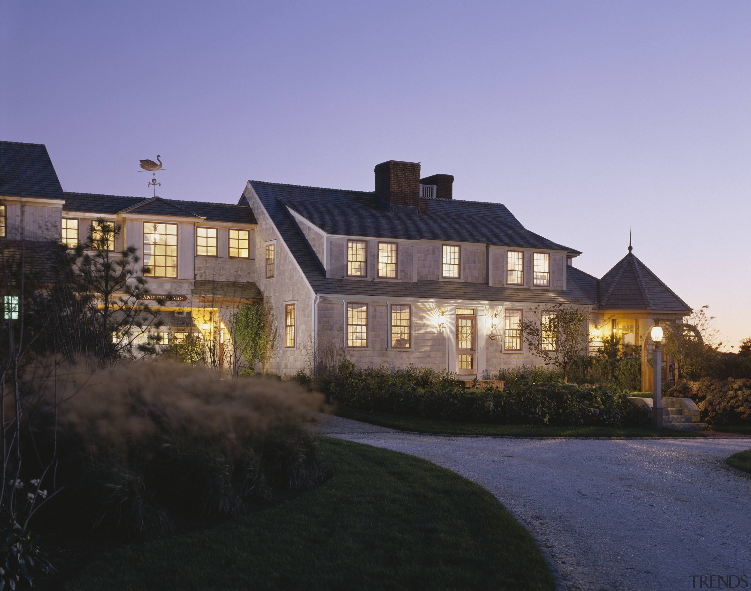 Exterior view of a large cottage with cedar building, cottage, estate, evening, facade, farmhouse, home, house, lighting, mansion, property, real estate, residential area, roof, sky, suburb, villa, window, black