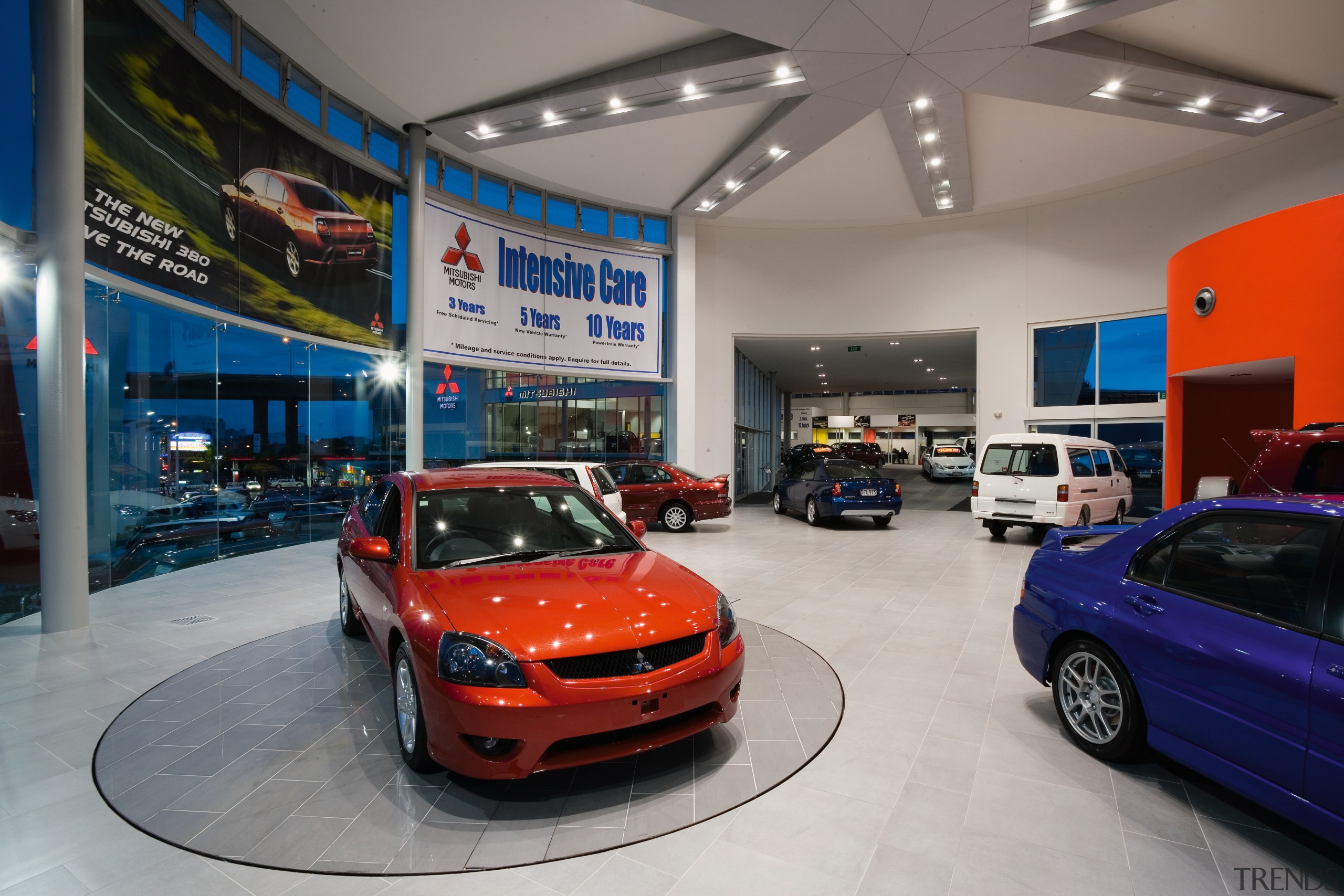 A view of the Mitsubishi Motors building. - auto show, automobile repair shop, automotive design, car, car dealership, exhibition, mid size car, motor vehicle, vehicle, gray