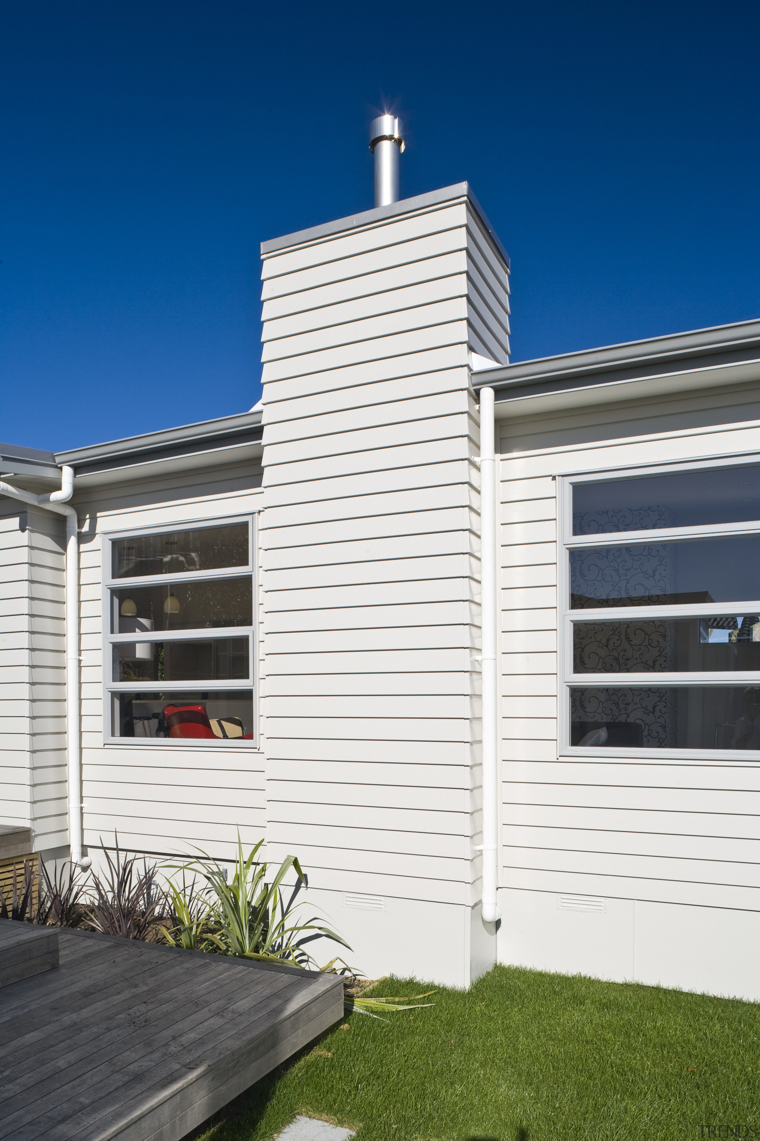 Exterior view of Harmony Homes show home which architecture, building, elevation, facade, home, house, property, real estate, residential area, siding, sky, window, white, blue
