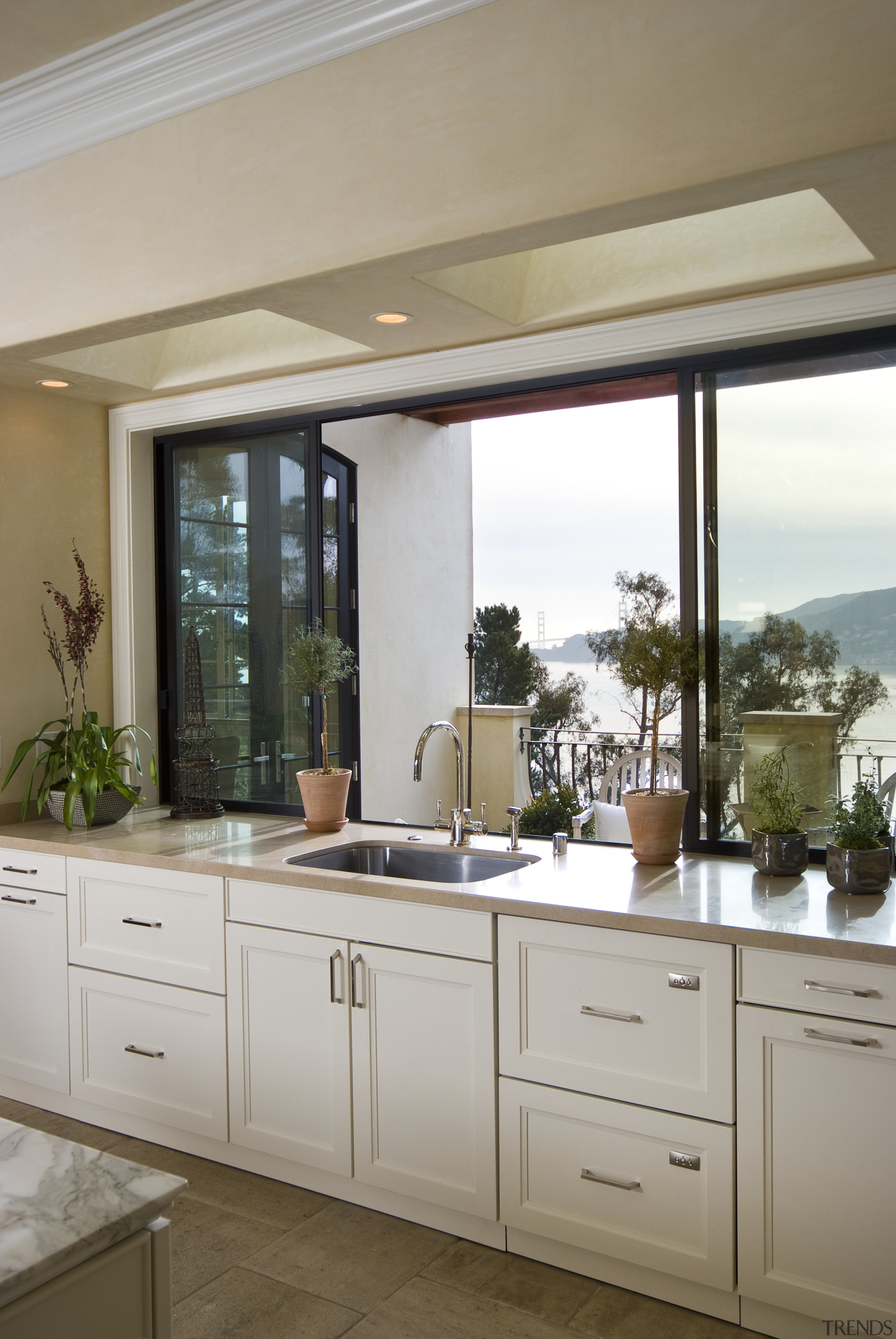 View of kitchen sink with white cabinetry. - cabinetry, countertop, cuisine classique, home, interior design, kitchen, room, sink, window, gray, brown