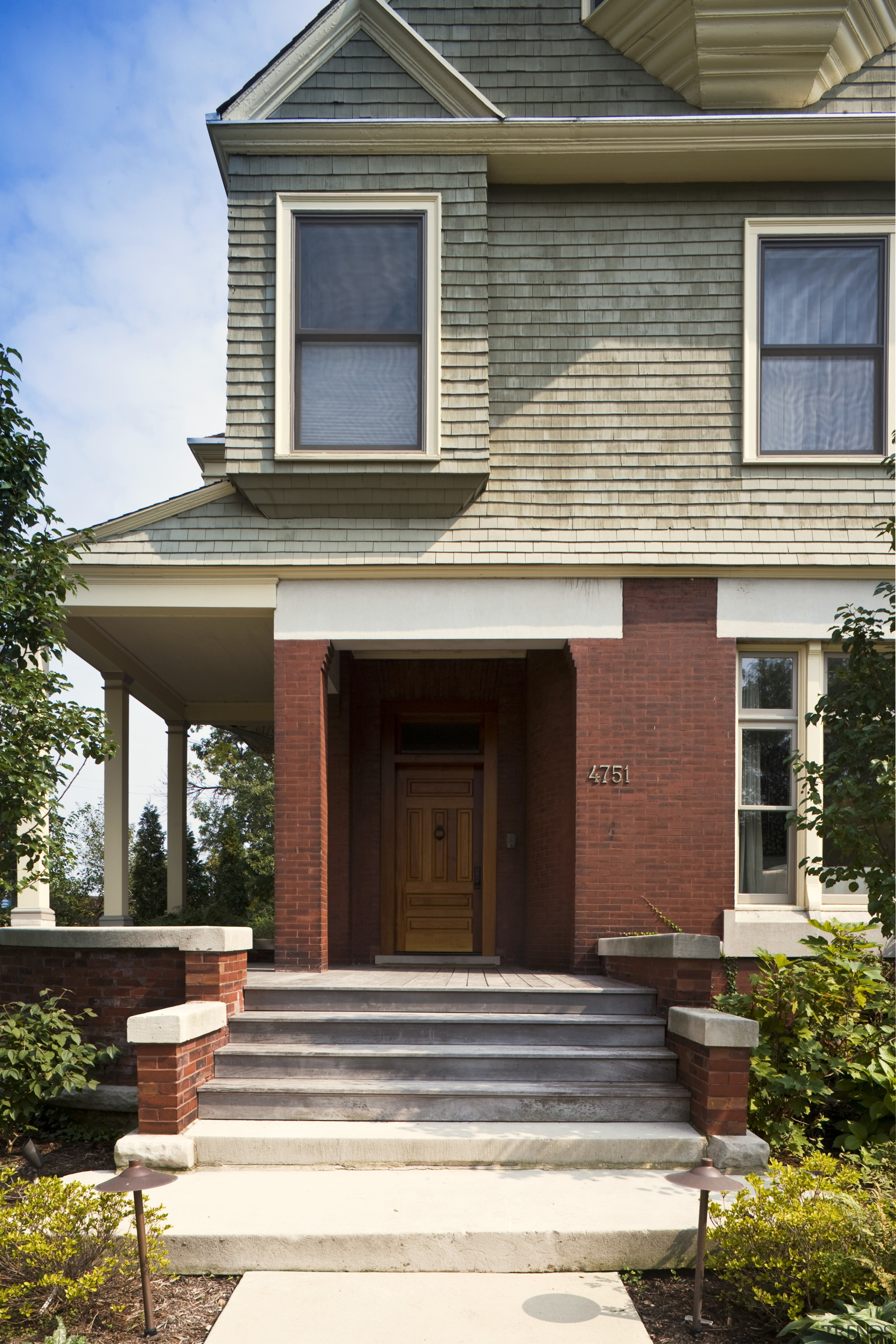Front entrance way of the house showing a architecture, building, elevation, estate, facade, home, house, neighbourhood, porch, property, real estate, residential area, siding, window, white, brown