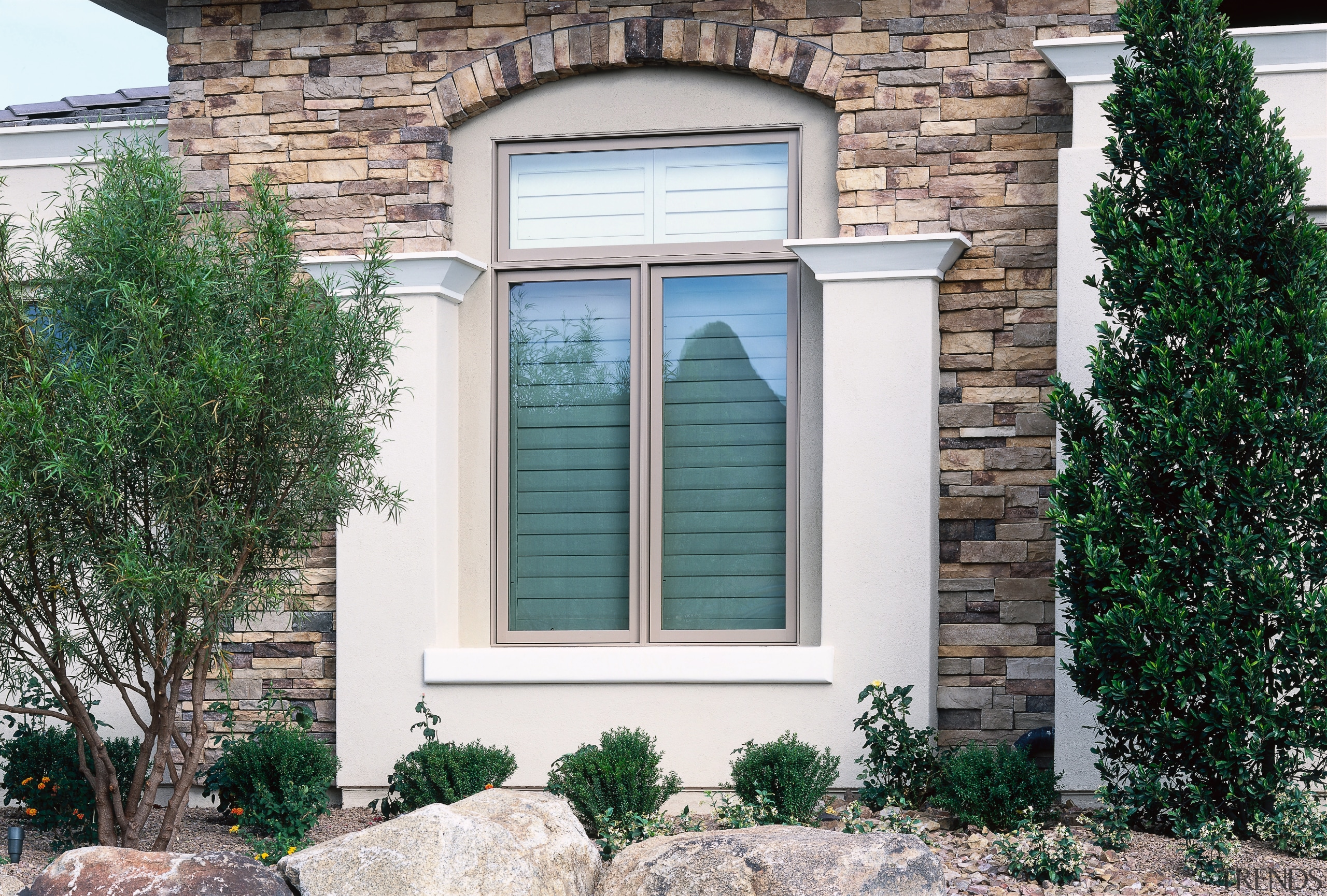 An exterior view of a window with wooden door, facade, home, house, real estate, sash window, siding, window, white