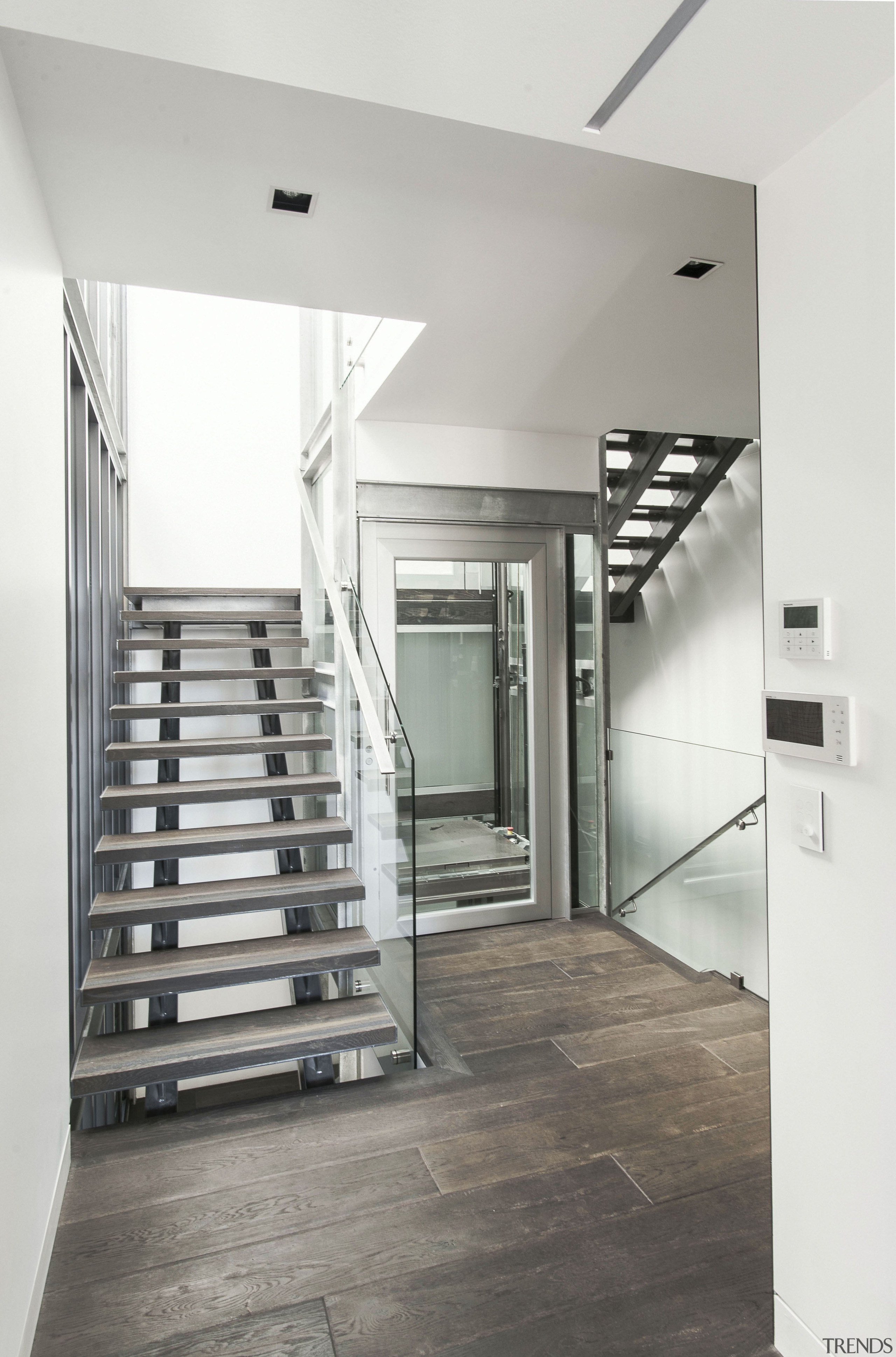 As well as having a glass-walled lift and architecture, ceiling, daylighting, floor, flooring, handrail, interior design, stairs, structure, wood flooring, gray, white