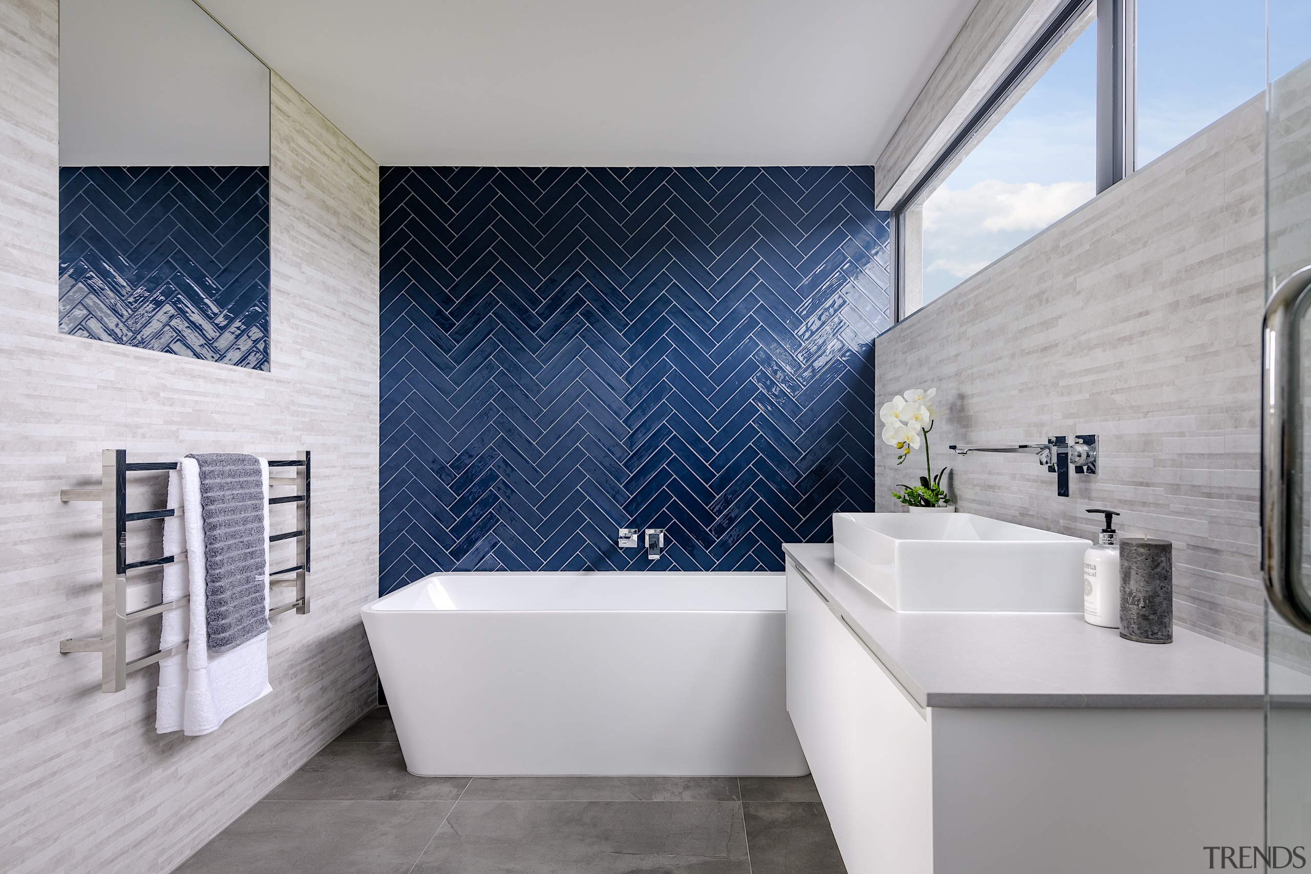 A bold feature wall of blue herringbone tiles 