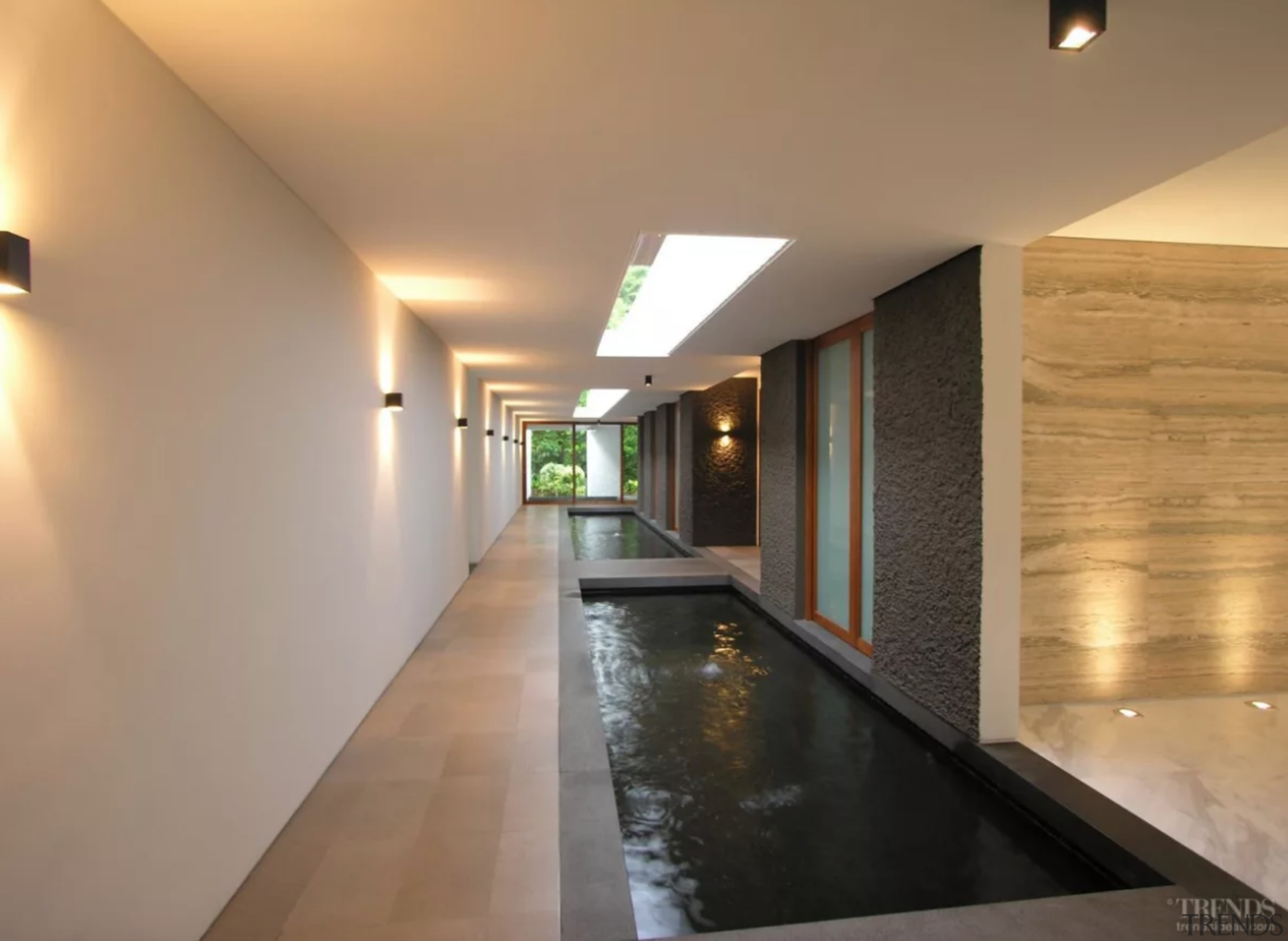 A 40m-long koi pond inside the house helps architecture, building, ceiling, floor, flooring, hall, house, interior design, lighting, lobby, property, real estate, room, wall, orange, brown