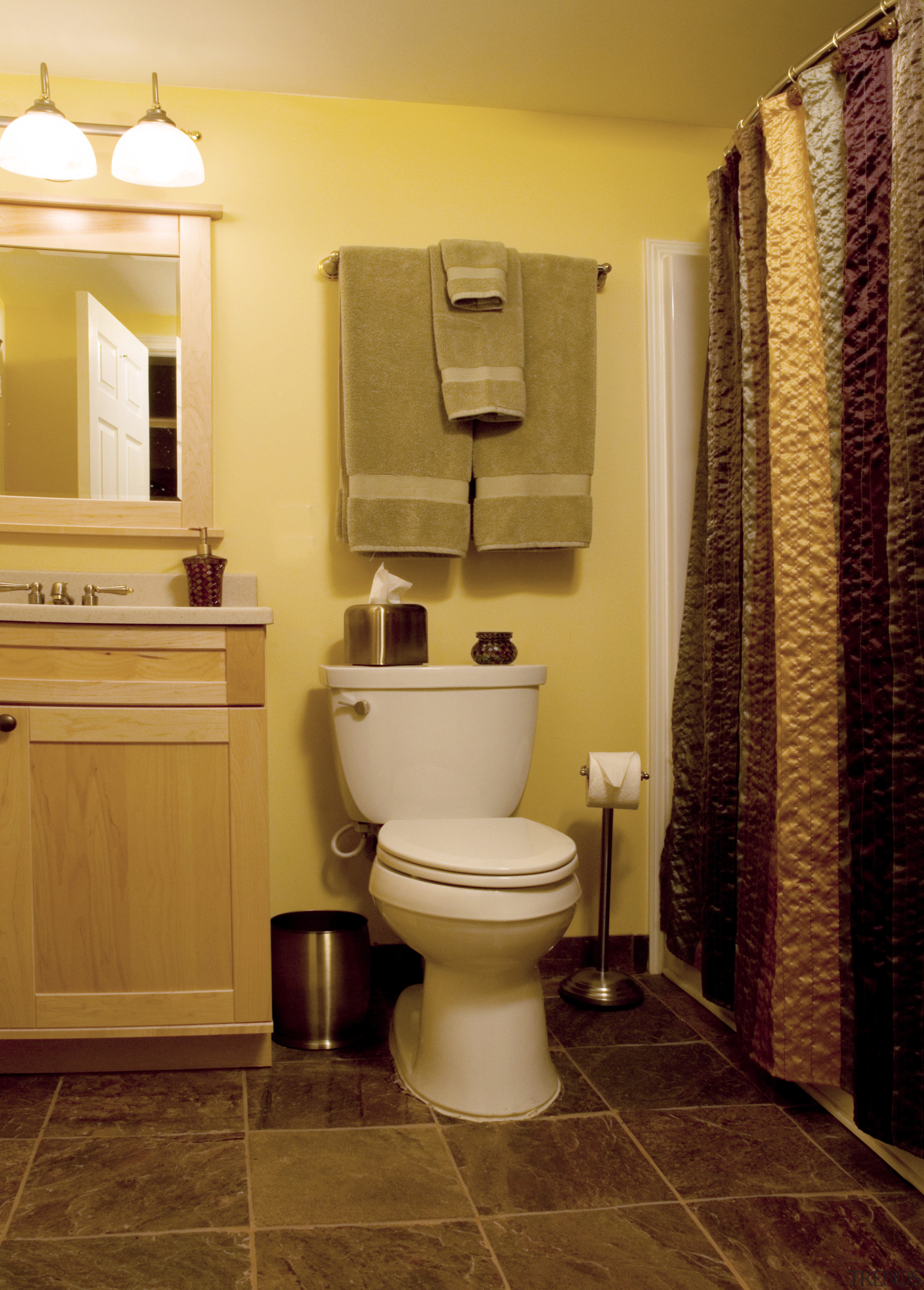 View of bathroom at in the basement entertainment bathroom, bathroom accessory, floor, flooring, hardwood, home, interior design, plumbing fixture, room, tile, toilet, wall, wood flooring, brown, orange