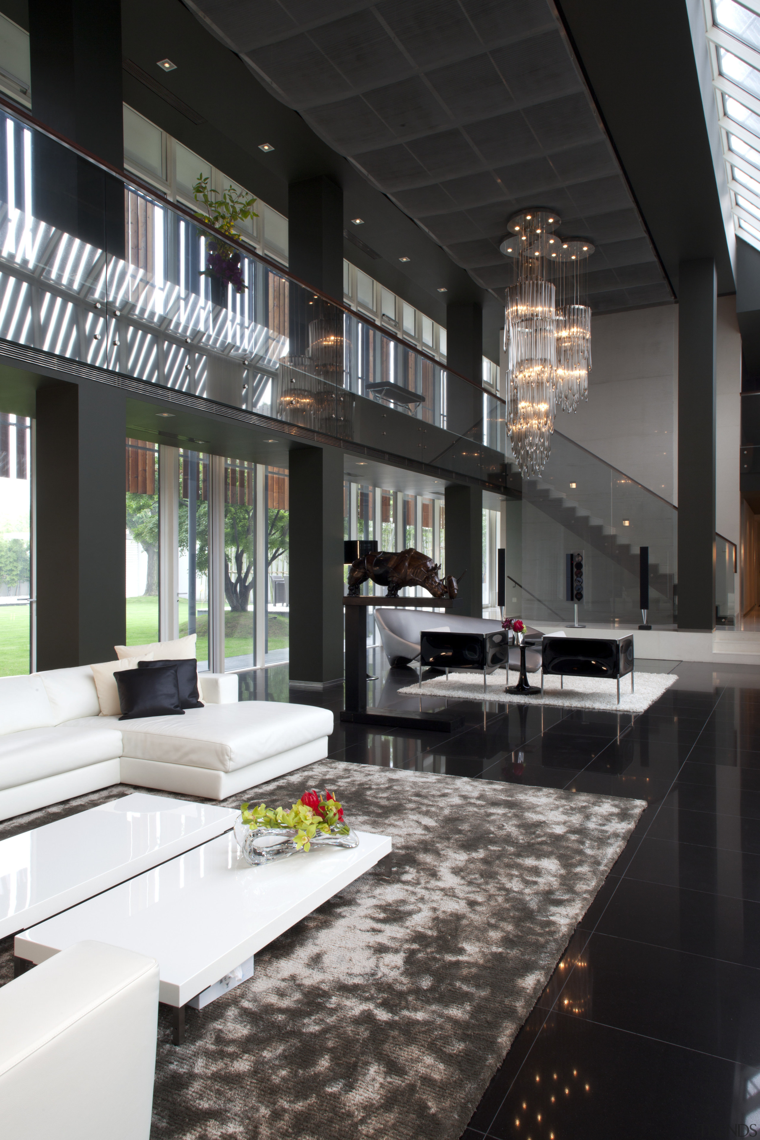 View of living area featuring white sofas, tiled architecture, floor, house, interior design, living room, black
