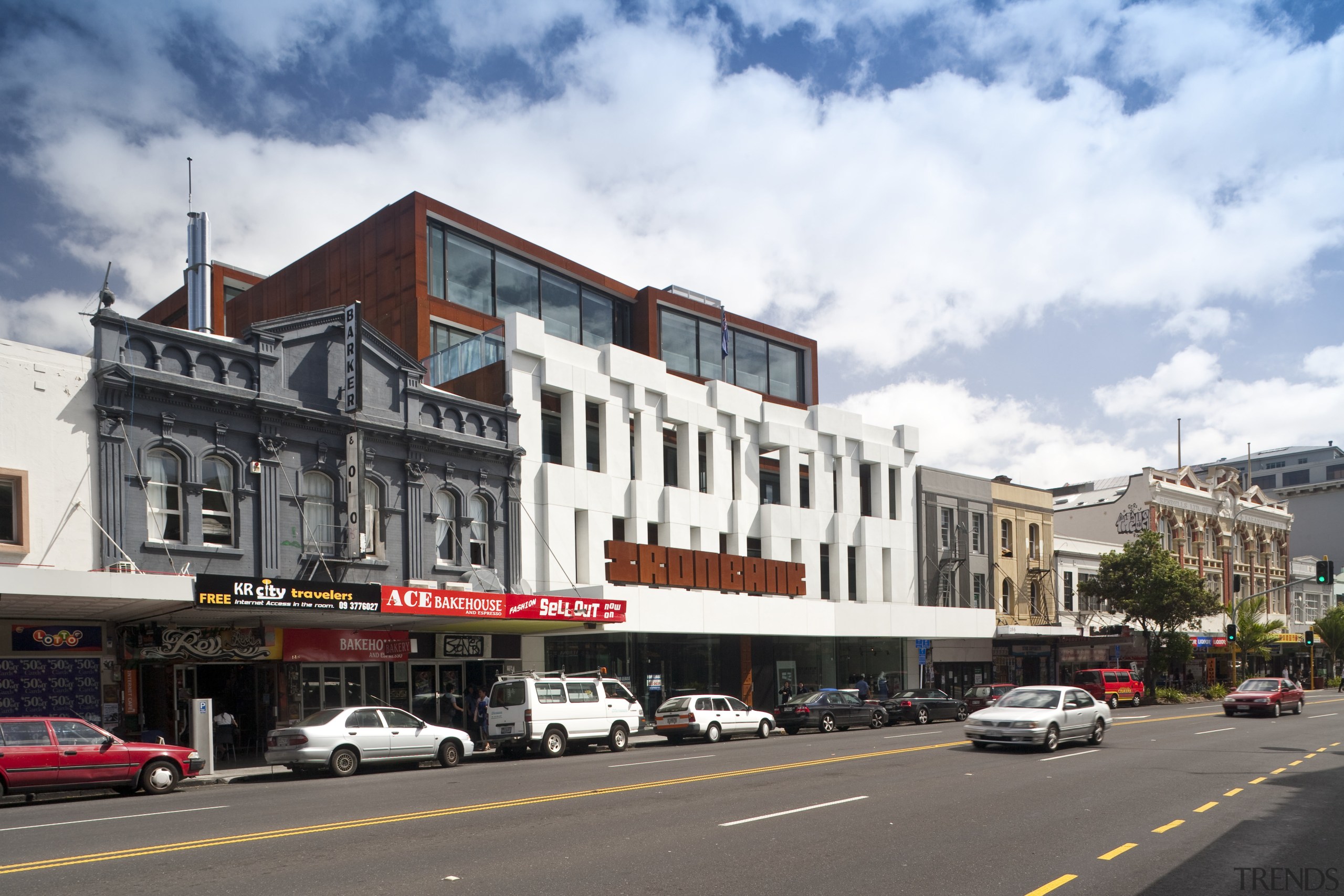 Exterior view of the Ironbank building which features architecture, building, car, city, commercial building, condominium, downtown, facade, family car, house, landmark, luxury vehicle, metropolis, metropolitan area, mixed use, neighbourhood, plaza, real estate, residential area, sky, street, town, urban area, white