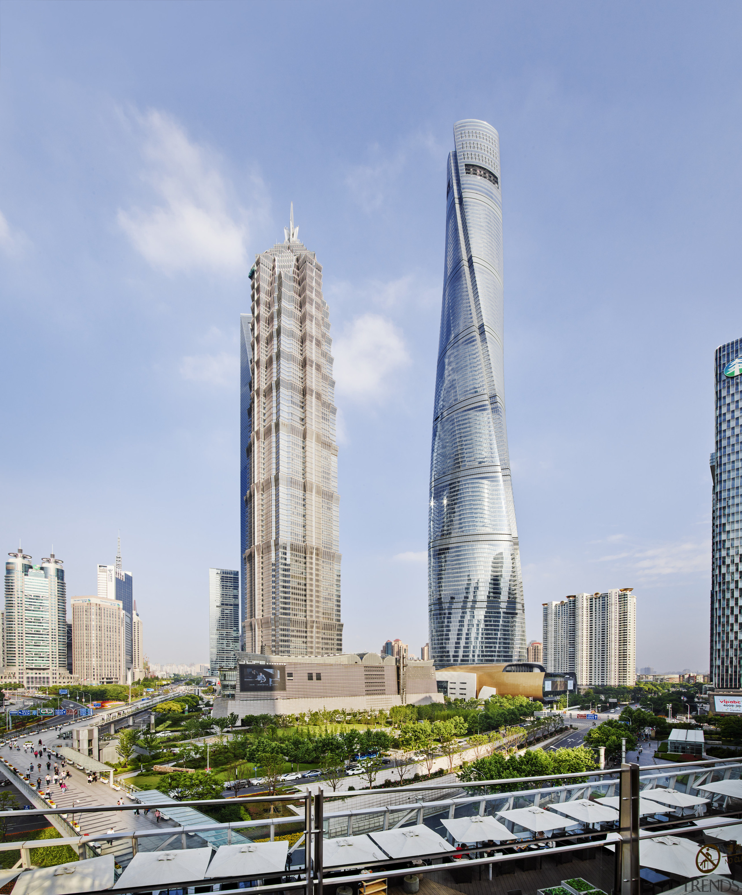 The twisting form of the Shanghai Tower stands building, city, cityscape, condominium, corporate headquarters, daytime, landmark, metropolis, metropolitan area, mixed use, sky, skyline, skyscraper, tower, tower block, urban area, teal