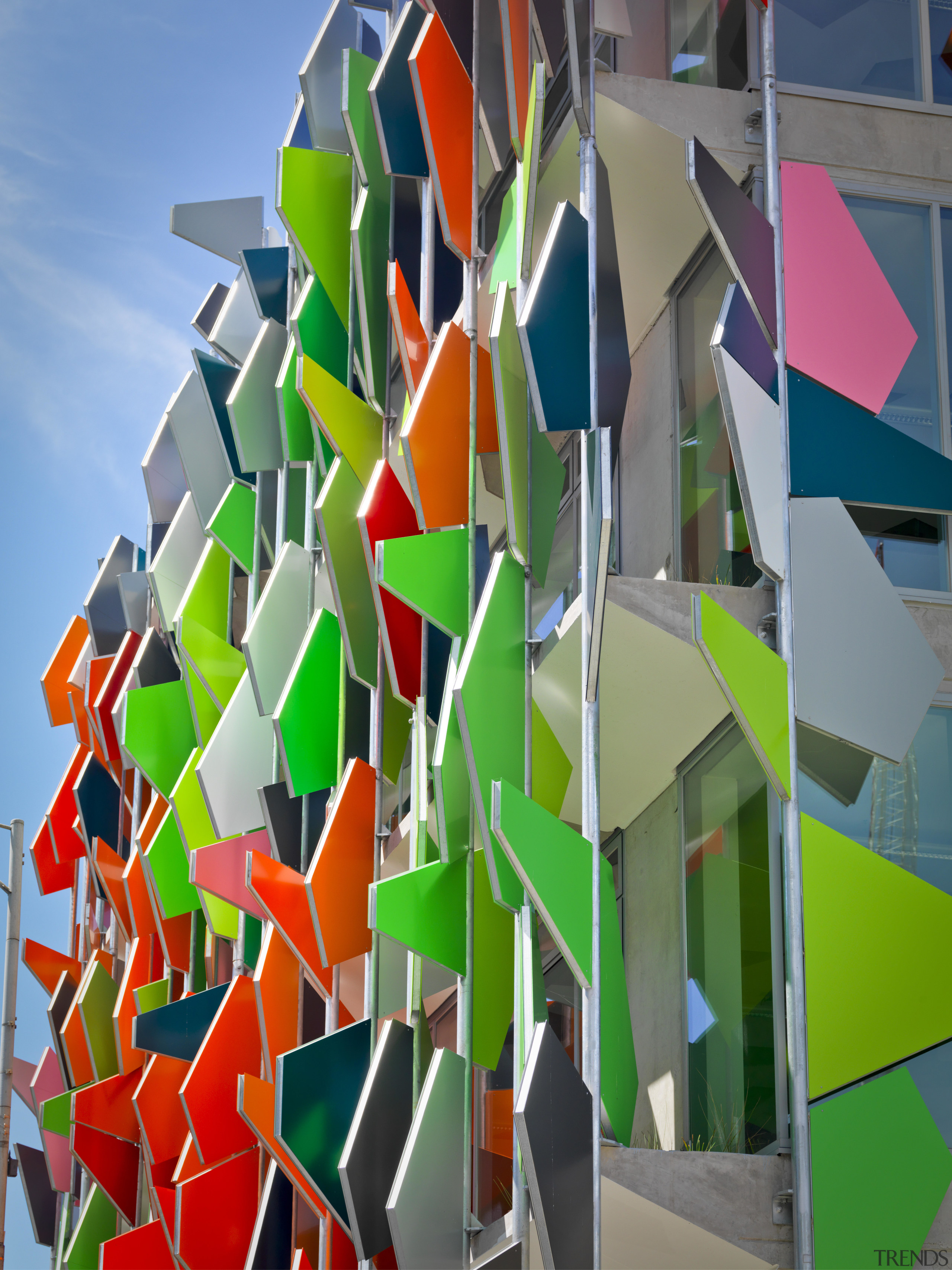 View of Pixel Building, with colorful exterior flags, architecture, art, design, line, structure, symmetry, gray