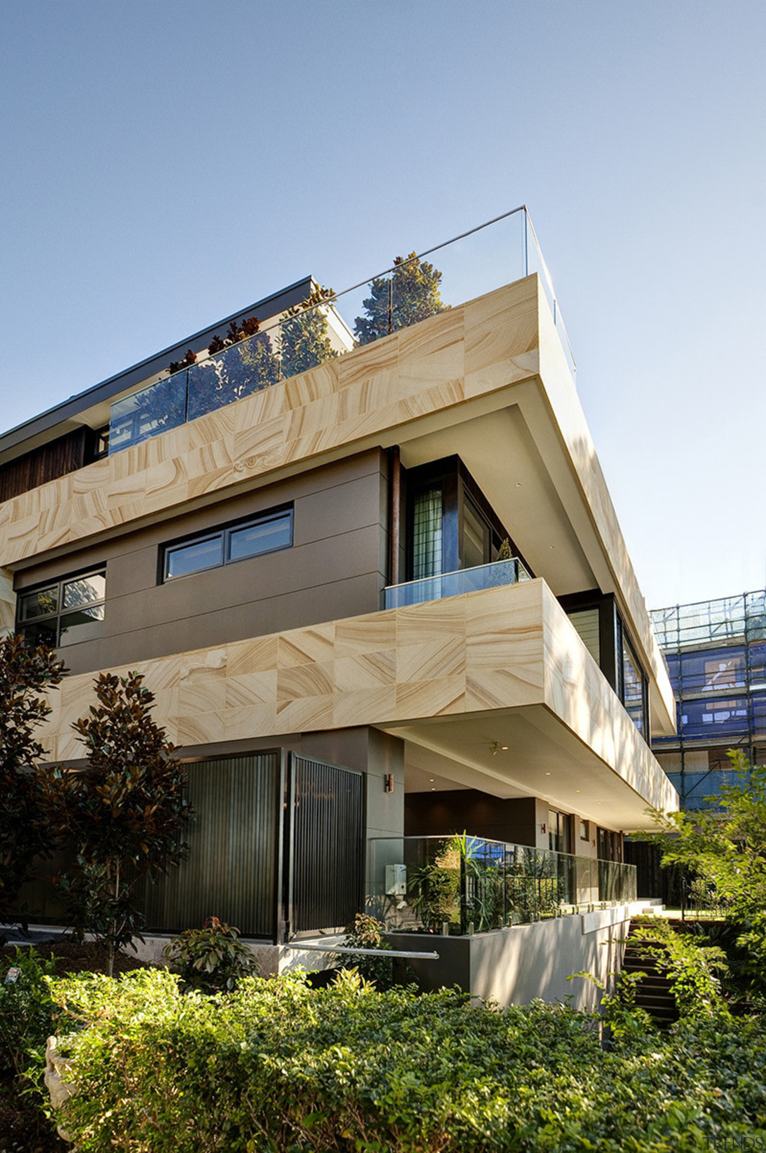 Set on a steep site, this three-level home apartment, architecture, building, condominium, facade, home, house, real estate, residential area, sky, teal