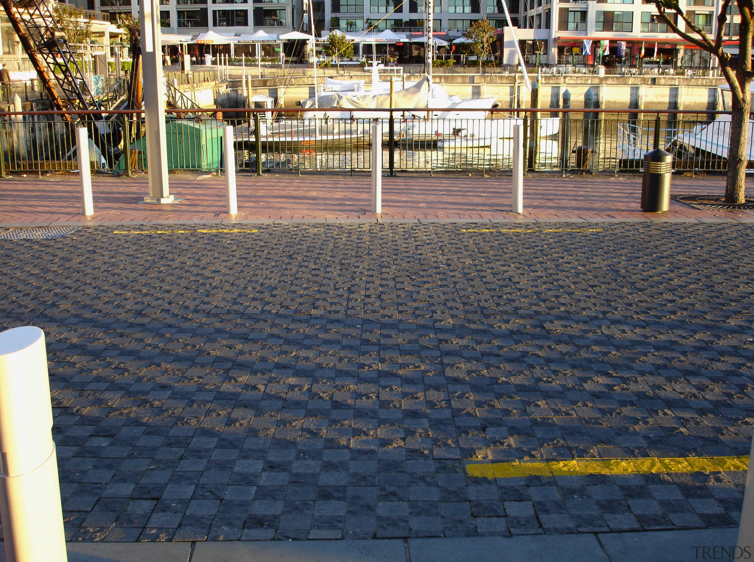 Patterned paving along waterfront. - Patterned paving along asphalt, floor, flooring, public space, road surface, sidewalk, structure, walkway