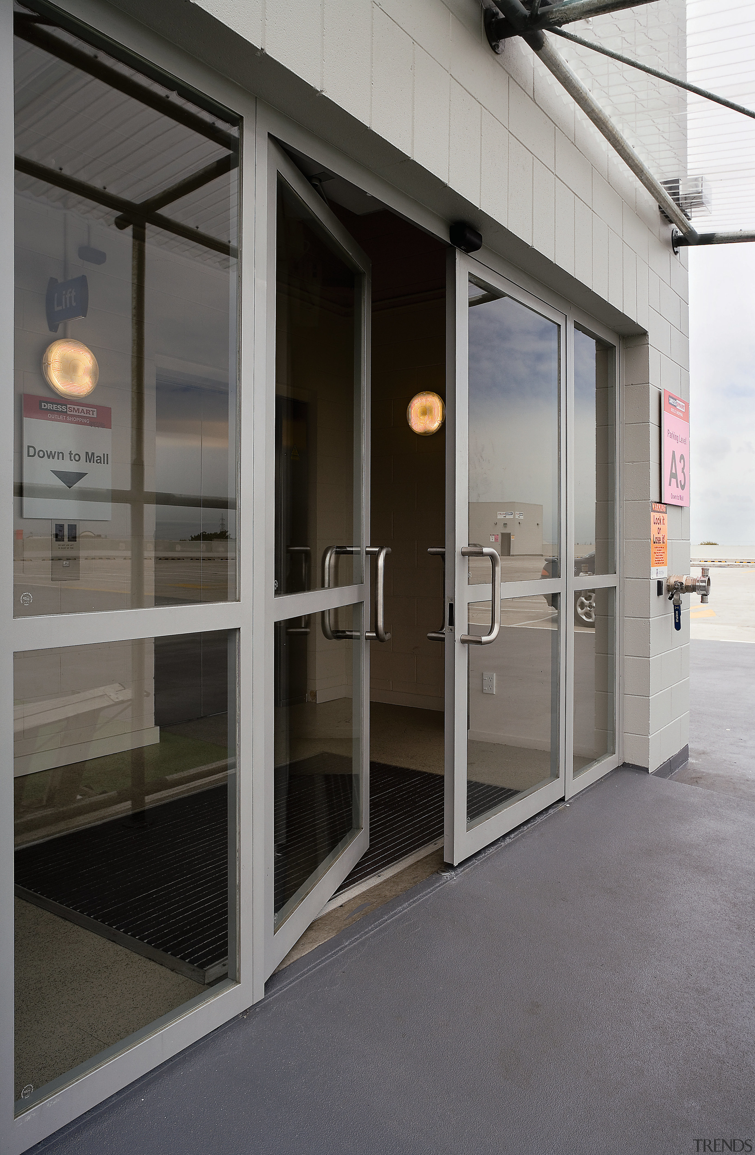view of the motion activated security doors constructed door, glass, window, gray, black