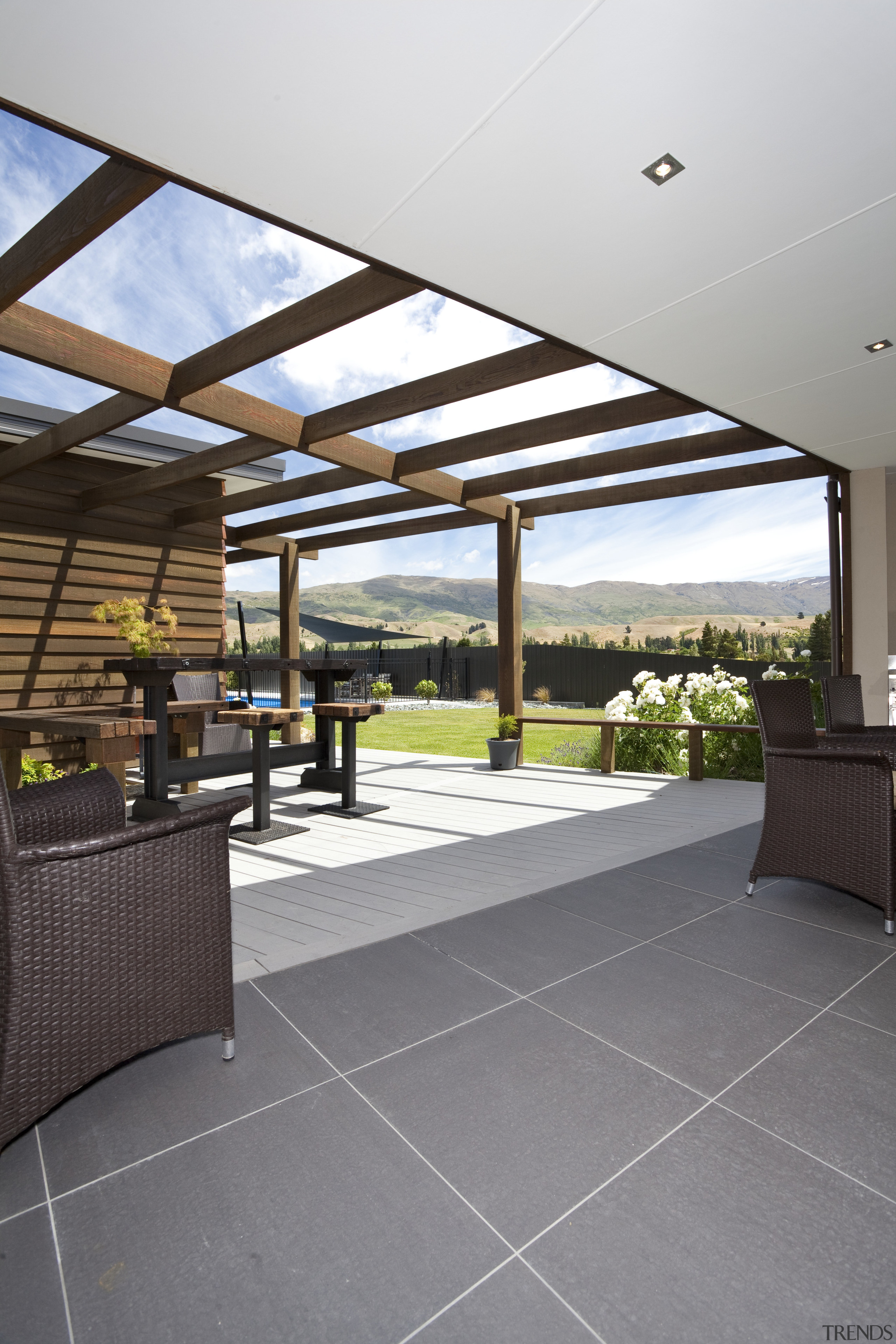 The flooring for this Otago home was chosen daylighting, estate, floor, flooring, house, interior design, lobby, outdoor structure, patio, property, real estate, roof, gray, white