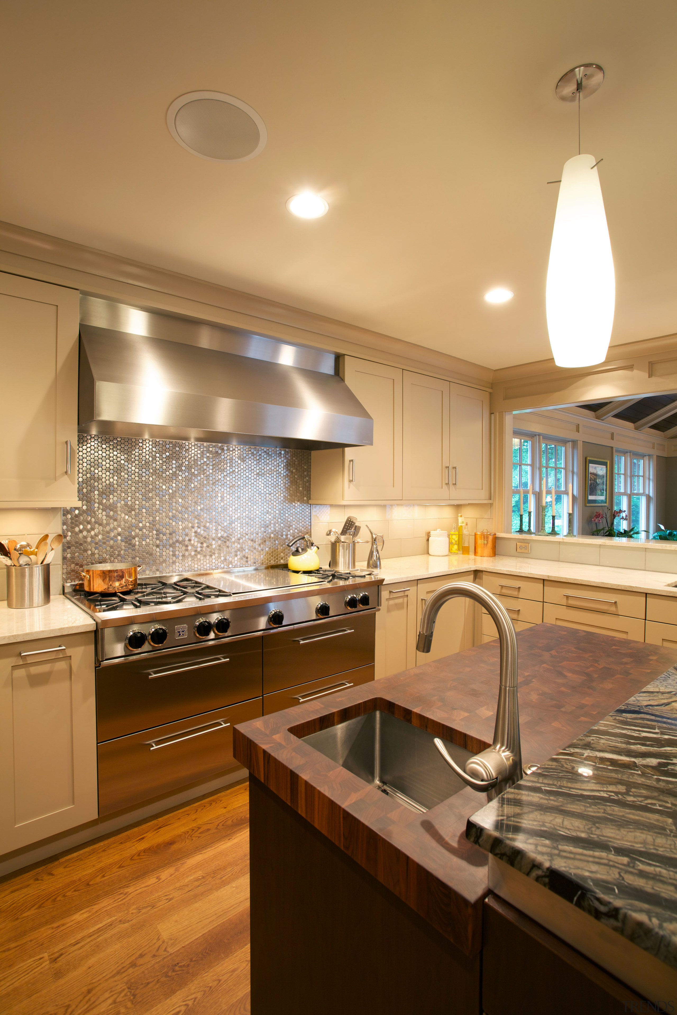 This butchers block is in end-grain walnut, connecting cabinetry, ceiling, countertop, cuisine classique, daylighting, flooring, hardwood, home, interior design, kitchen, real estate, room, under cabinet lighting, wood flooring, brown, orange