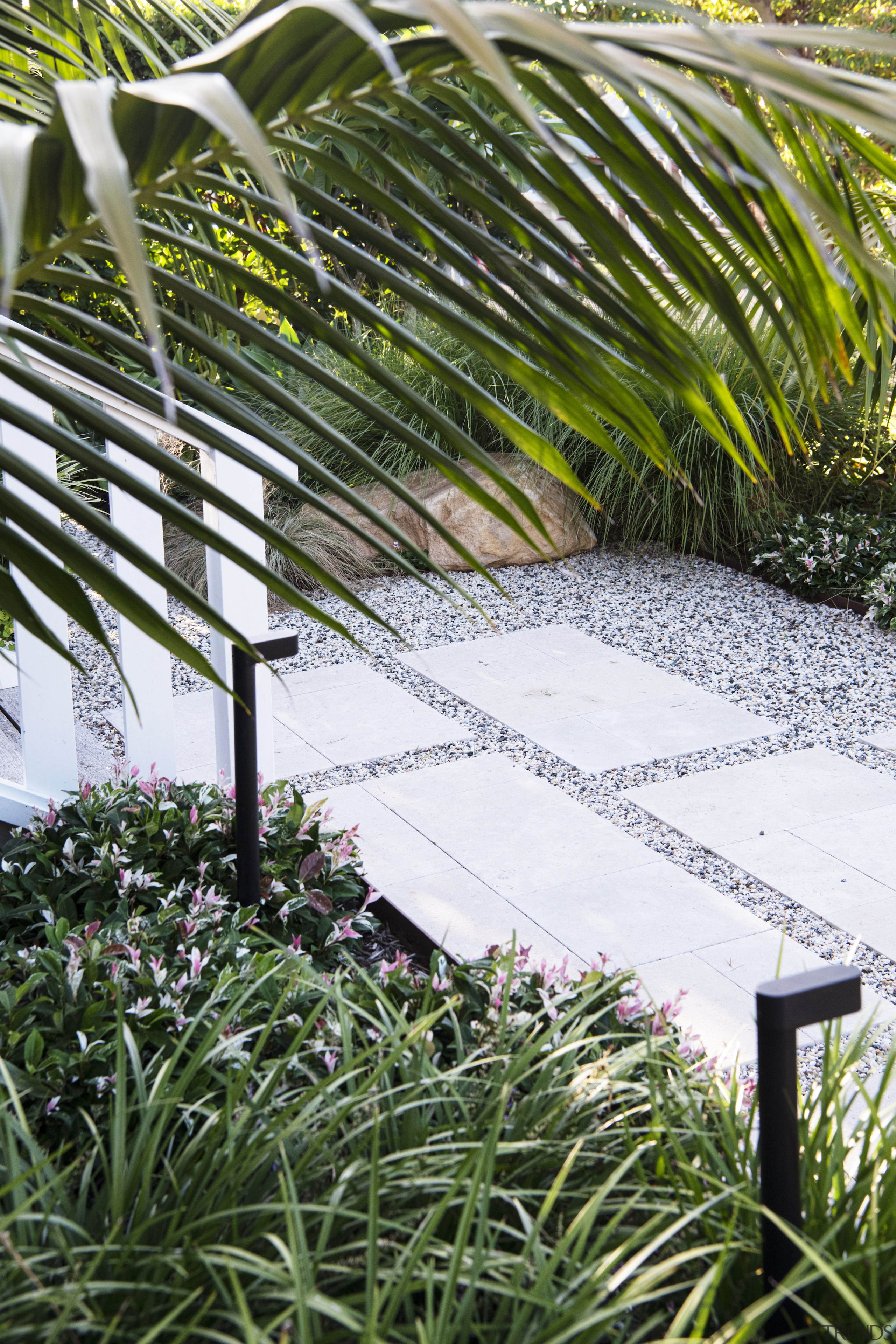 Front steps, lighting and lush, low-upkeep plantings. 