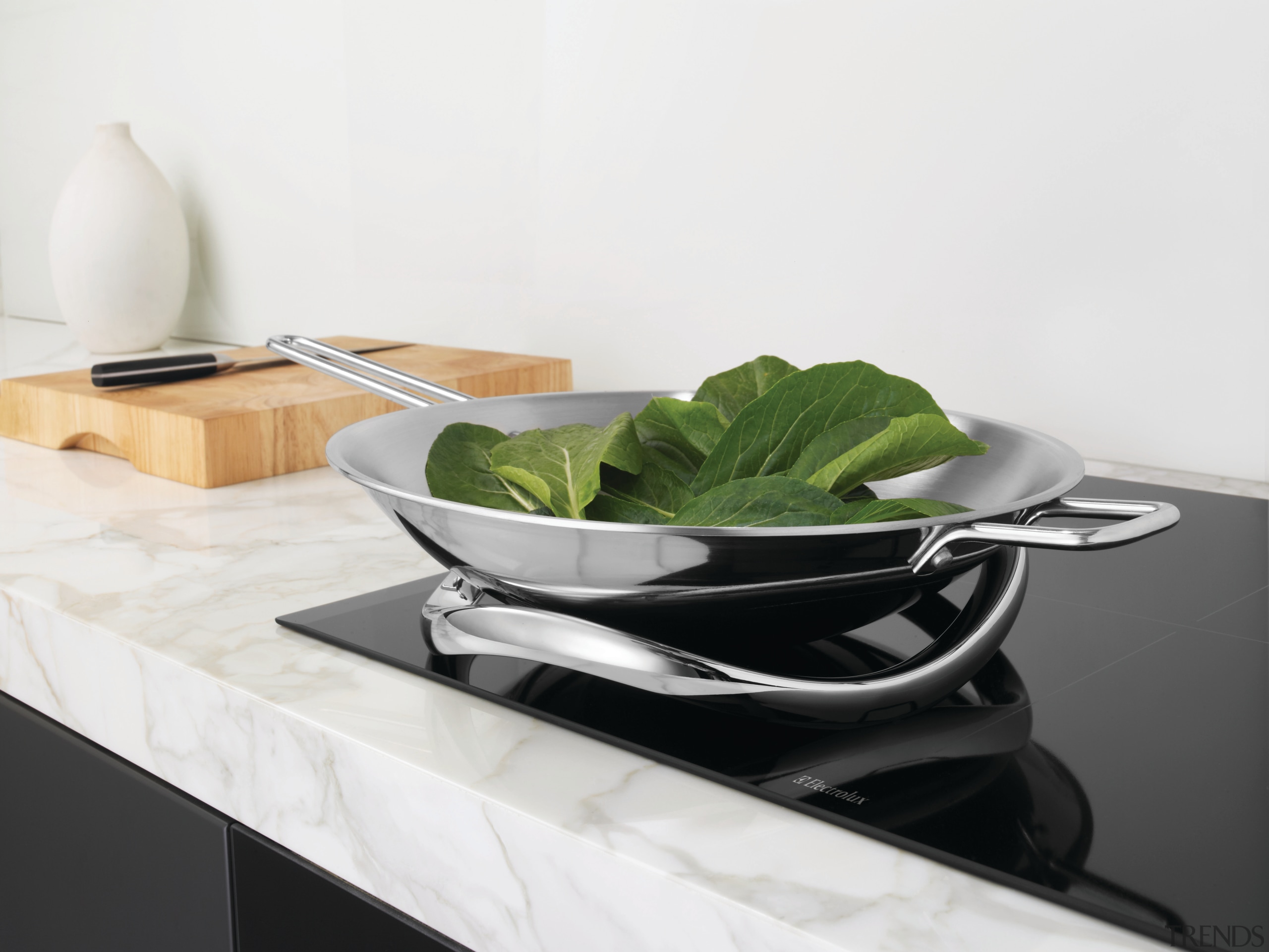 View of a contemporary kitchen which features dark bowl, cookware and bakeware, furniture, product design, serveware, table, tableware, white