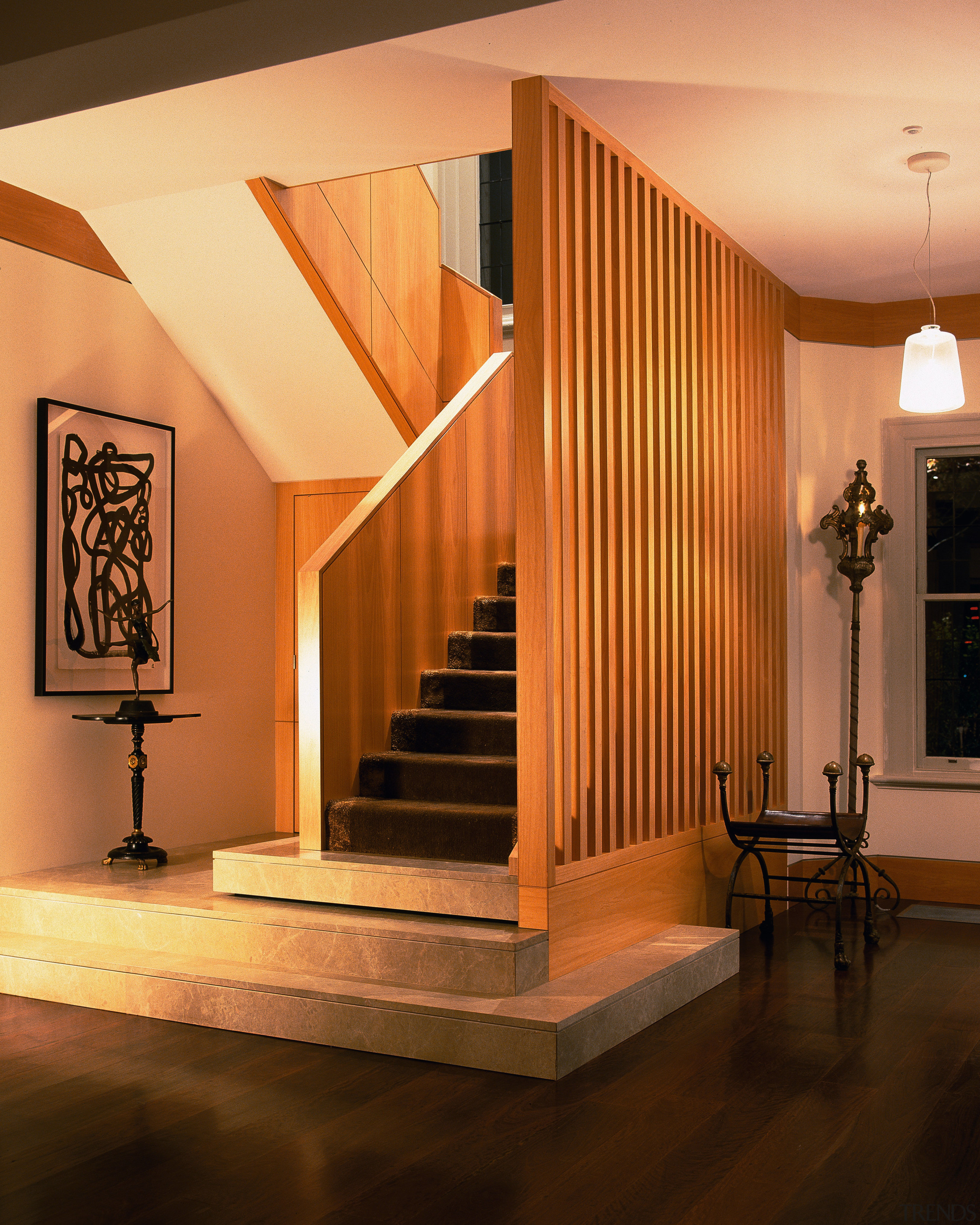 Image of timber staircase with marble stairs at architecture, baluster, ceiling, floor, flooring, furniture, handrail, hardwood, home, interior design, lighting, living room, lobby, stairs, wall, wood, brown, orange