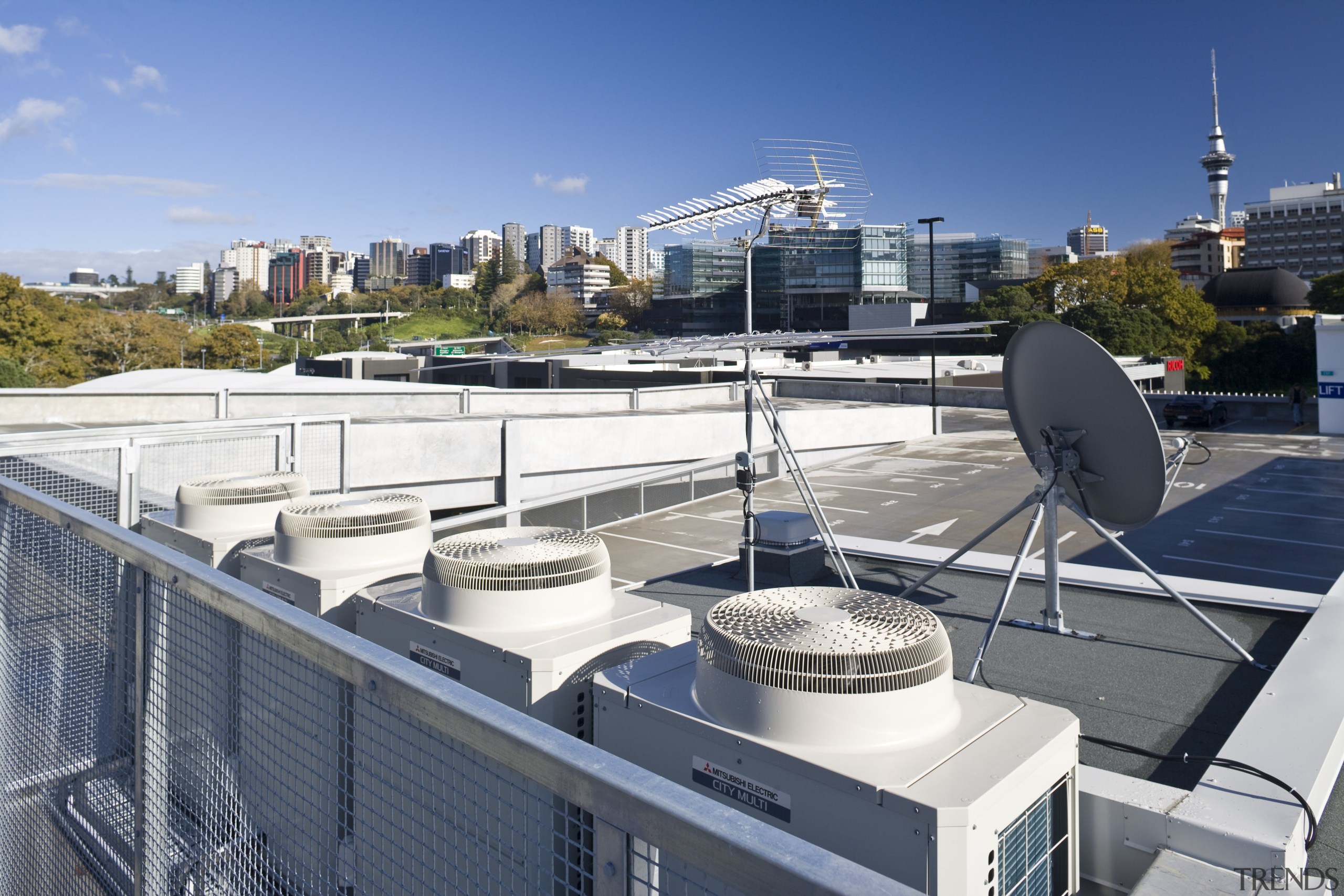 View of air conditioning and ventilation system at apartment, city, condominium, downtown, metropolitan area, real estate, roof, sky, urban area, water, gray